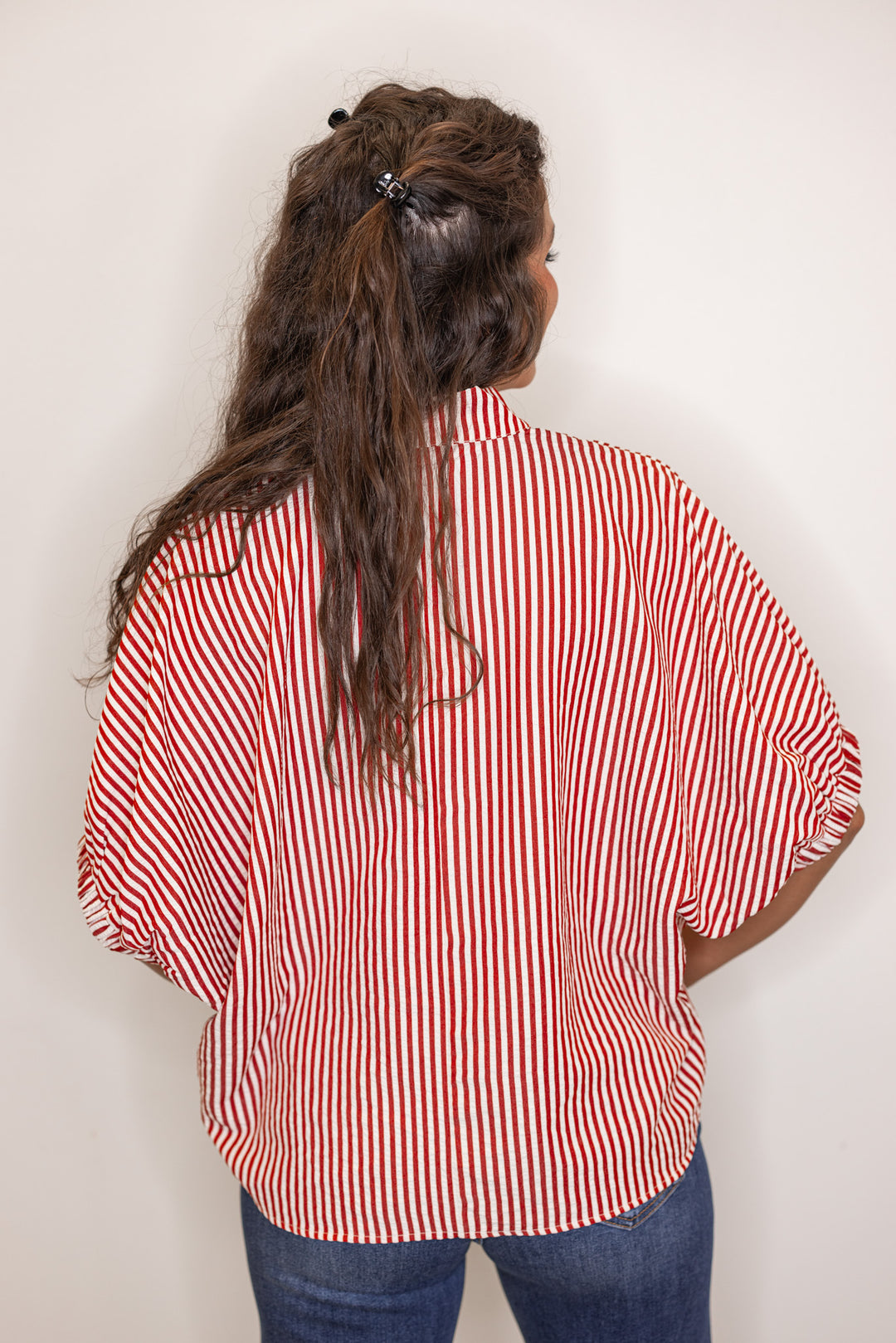 back view of Women's brick red striped short sleeve top