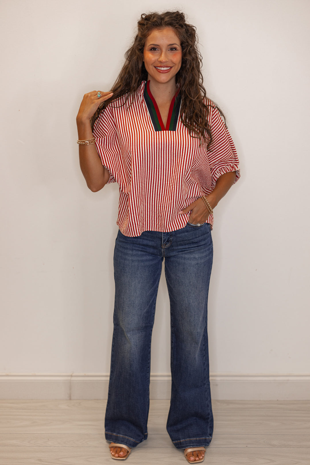 Women's brick red striped short sleeve top paired with flare leg denim