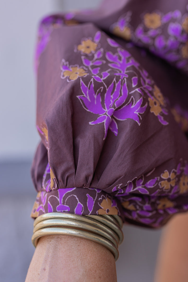 Women's chocolate brown button front poplin top with orange and purple florals by Entro showing cuffed balloon sleeves