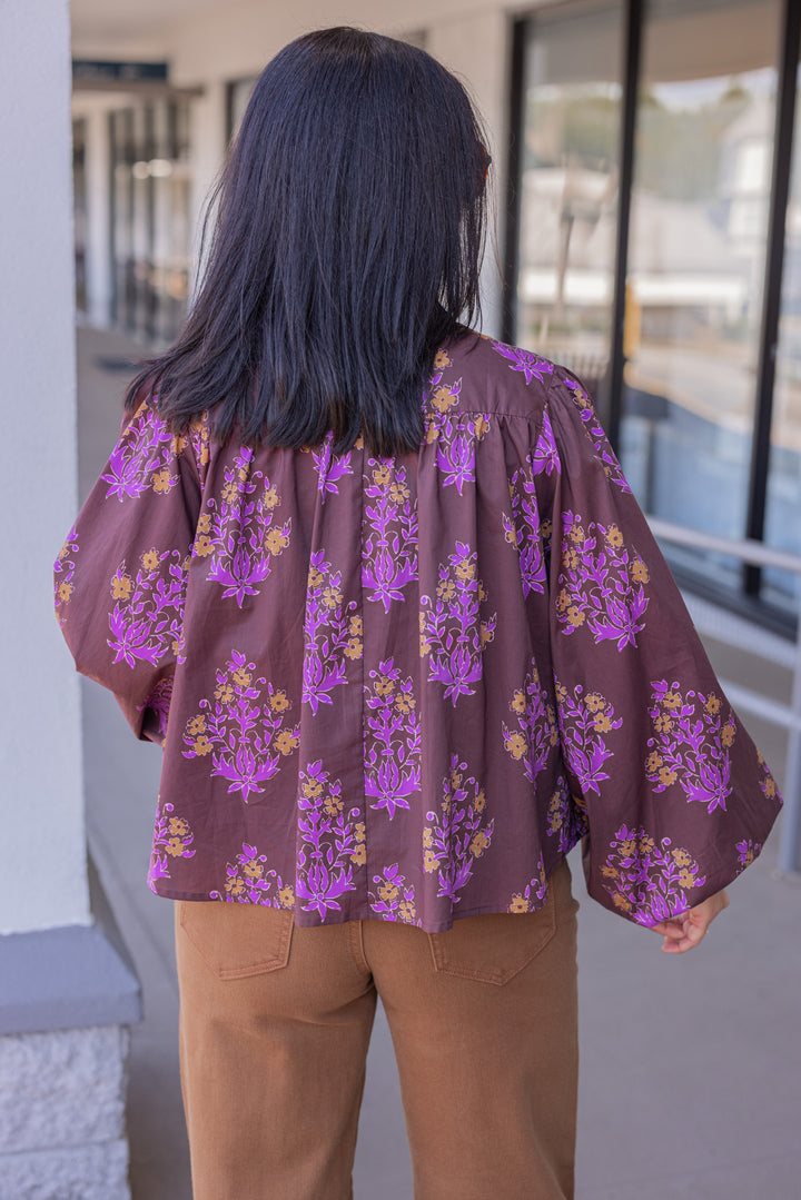 Women's chocolate brown button front poplin top with orange and purple florals by Entro showing back view