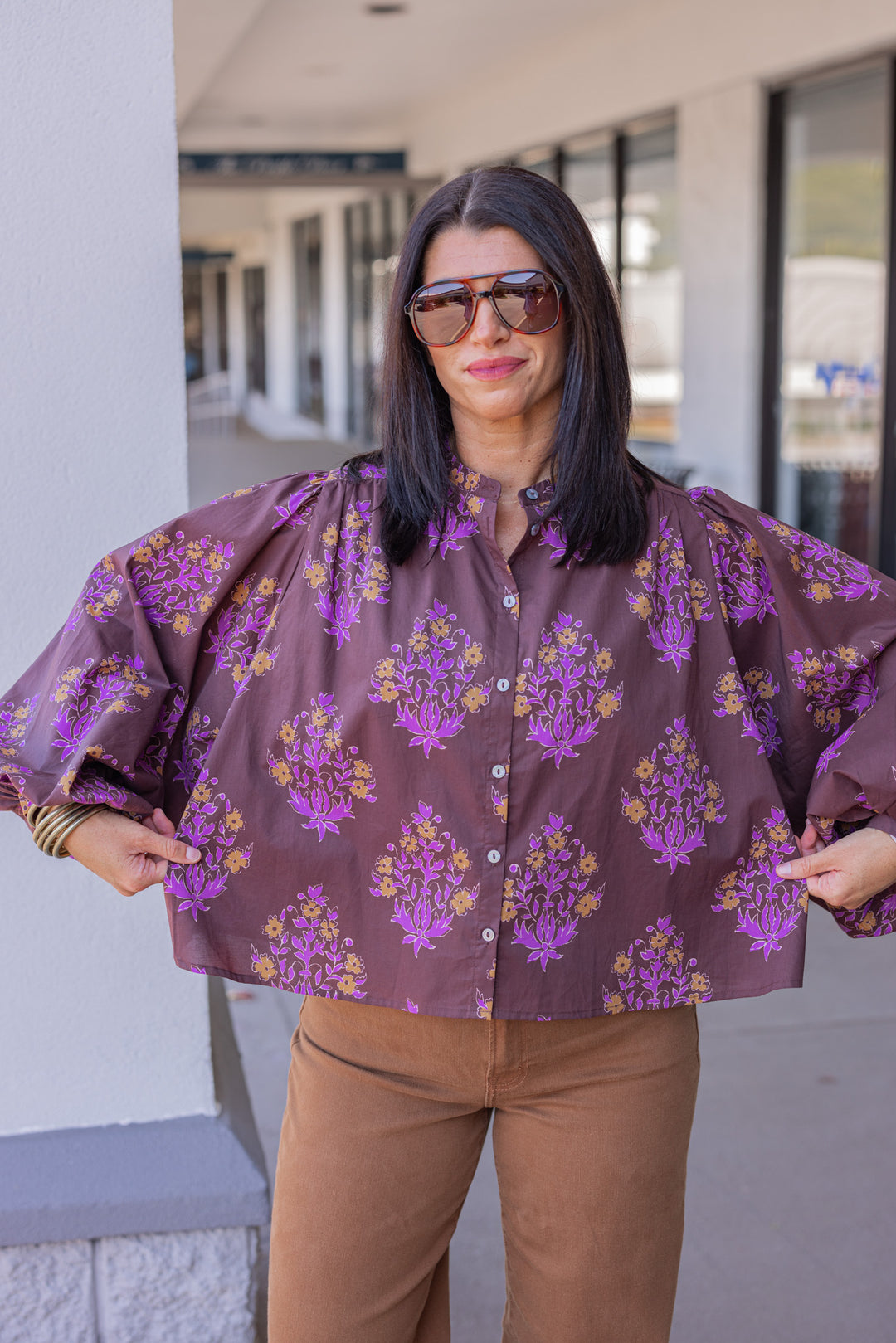 Women's chocolate brown button front poplin top with orange and purple florals by Entro showing true to size fit