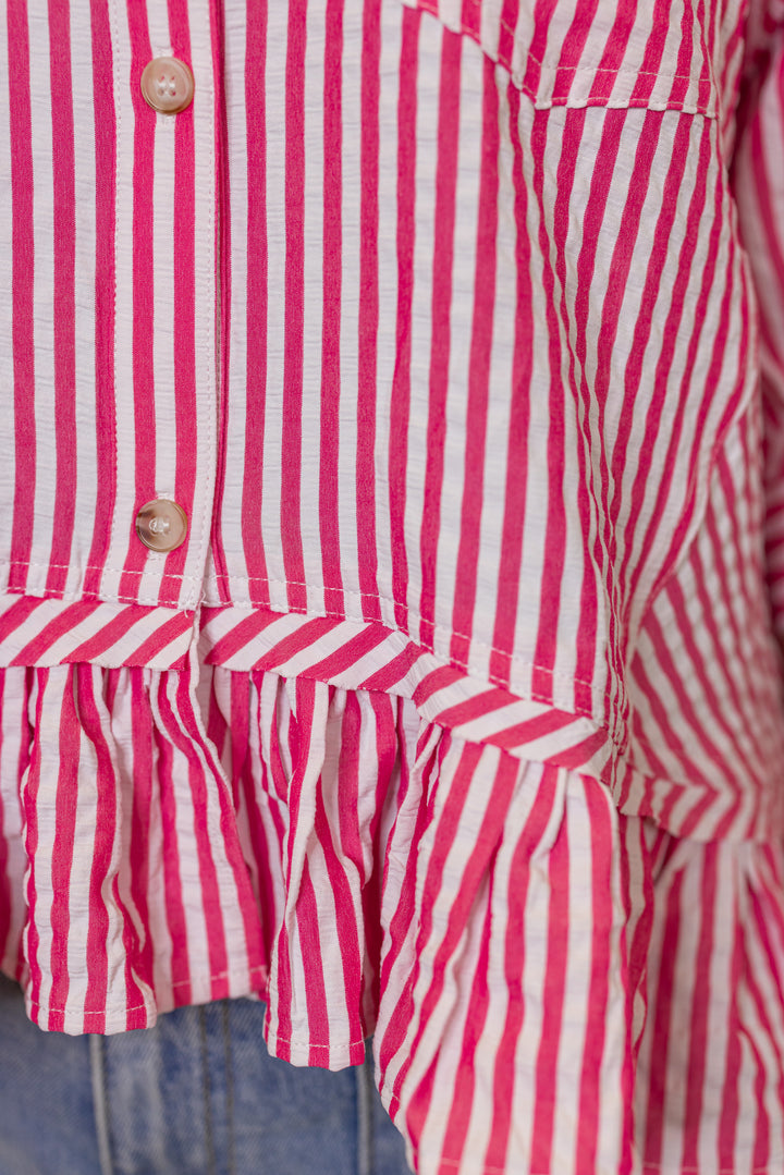 Women's pink summer striped button down top with ruffled bottom hem by Entro showing hem detailing