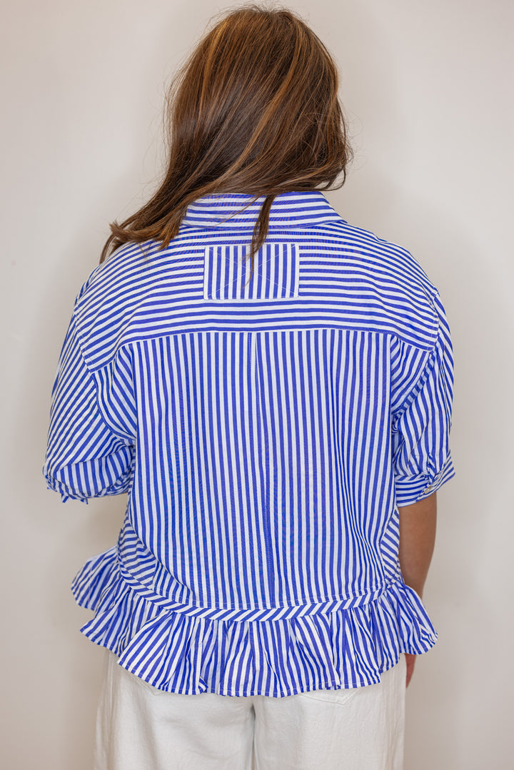 Women's blue summer striped button down top with ruffled bottom hem by Entro showing back view