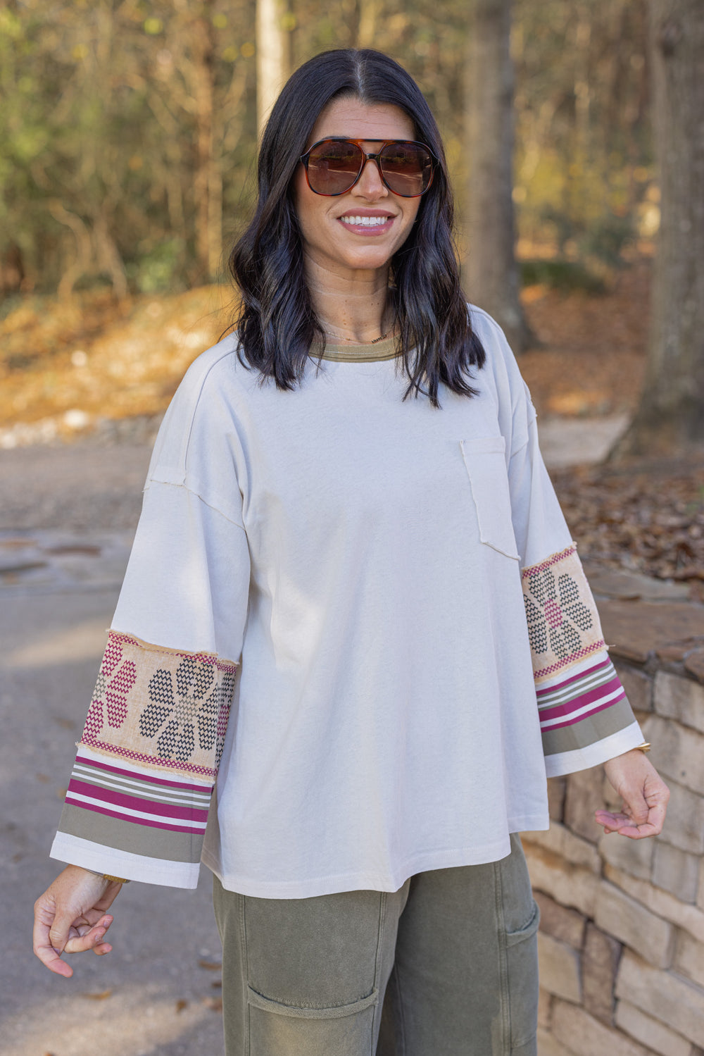 Women's washed ecru knit top with striped trim and floral details at the sleeves by Easel showing slight angled front view