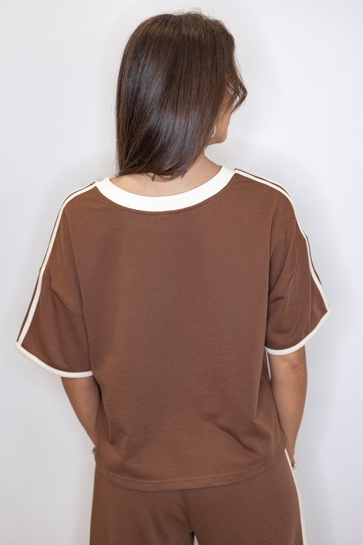Women's brown french terry knit top with cream stripes on the sleeve by Entro showing up close back view