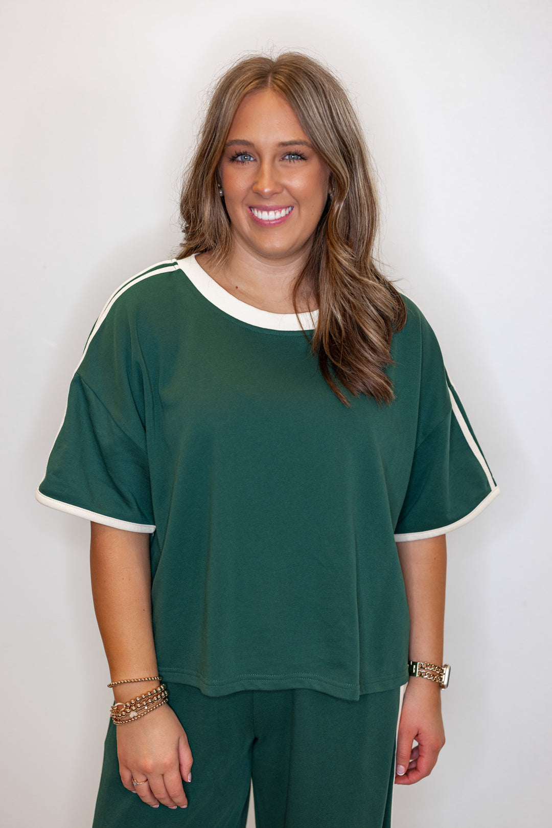 Women's hunter green french terry knit top with cream stripes on the sleeve by Entro