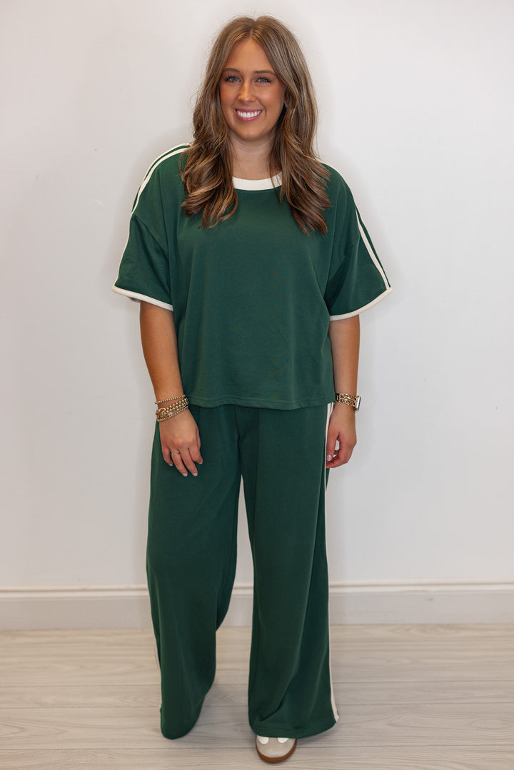 Women's hunter green terry knit wide leg pants with cream stripes on the side by Entro showing full front view