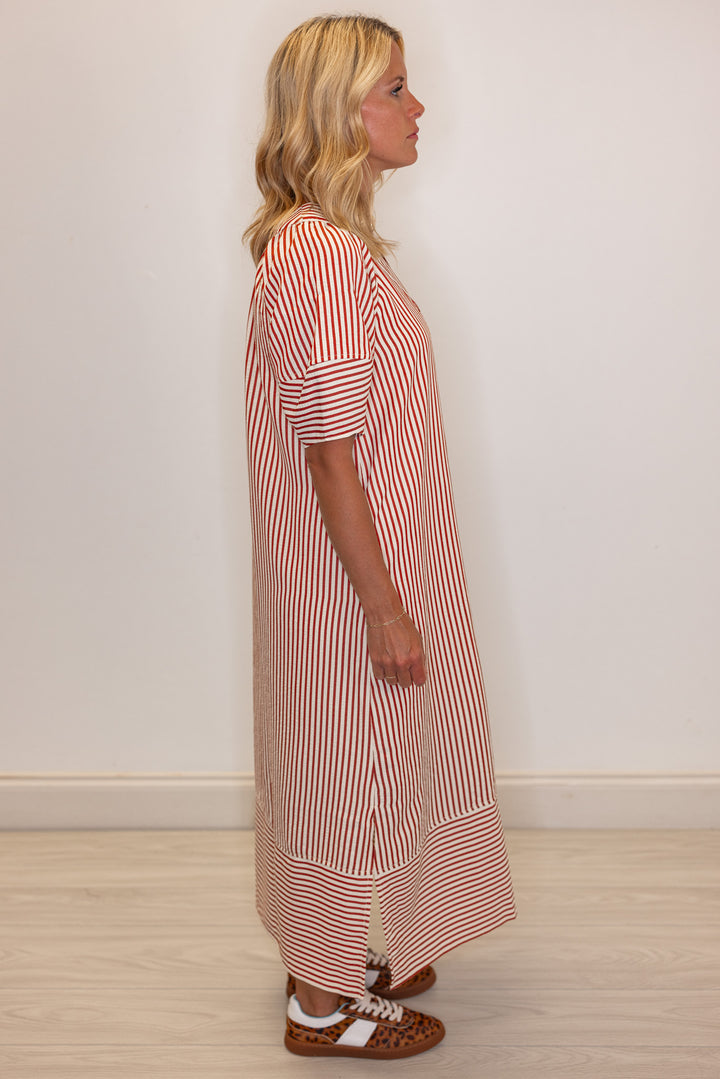 Women's rust and ivory striped midi dress by Entro showing side view