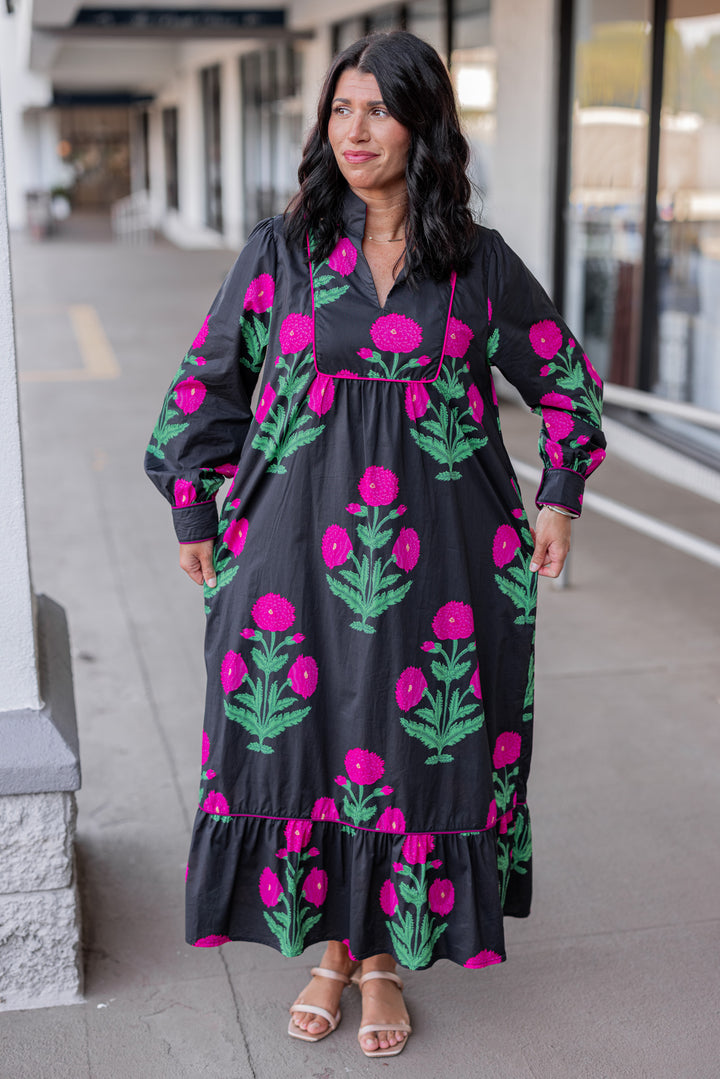 Women's black midi dress with hot pink floral print and hot pink piping trim by Jodifl showing relaxed silouhette