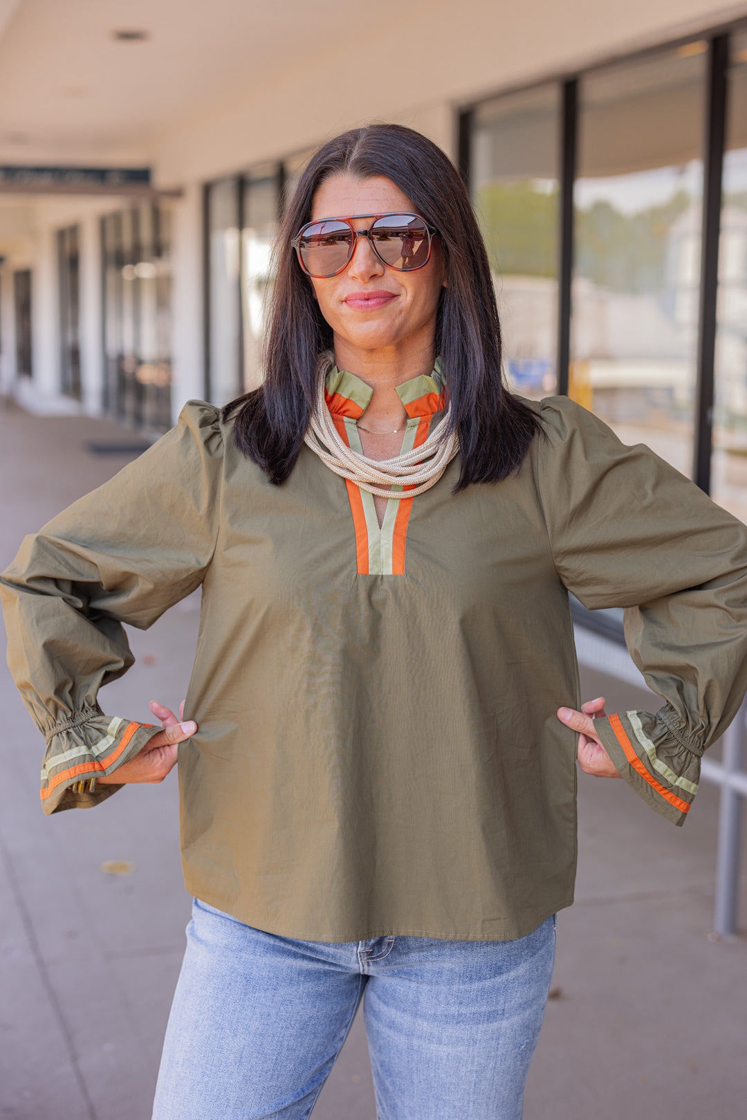 Women's olive poplin top with orange and light olive trim by Jodifl showing true to size fit