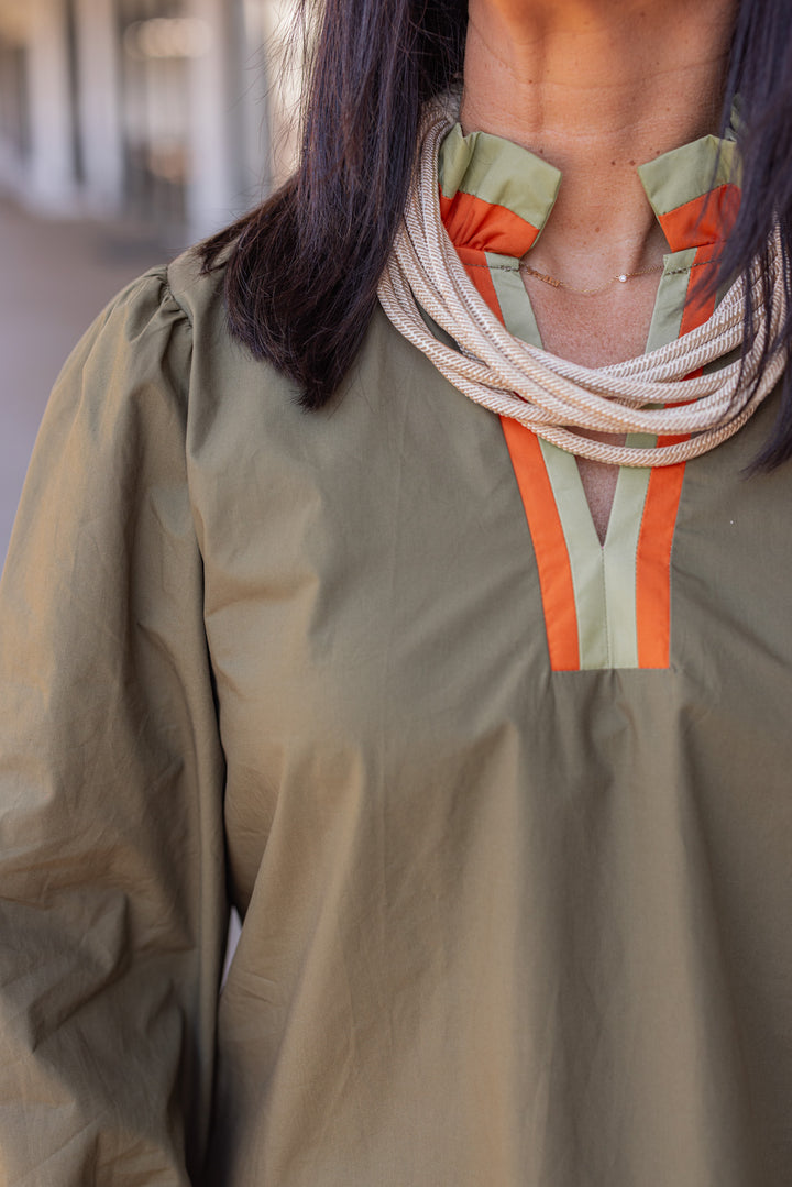 Women's olive poplin top with orange and light olive trim by Jodifl showing up close front view of neckline details