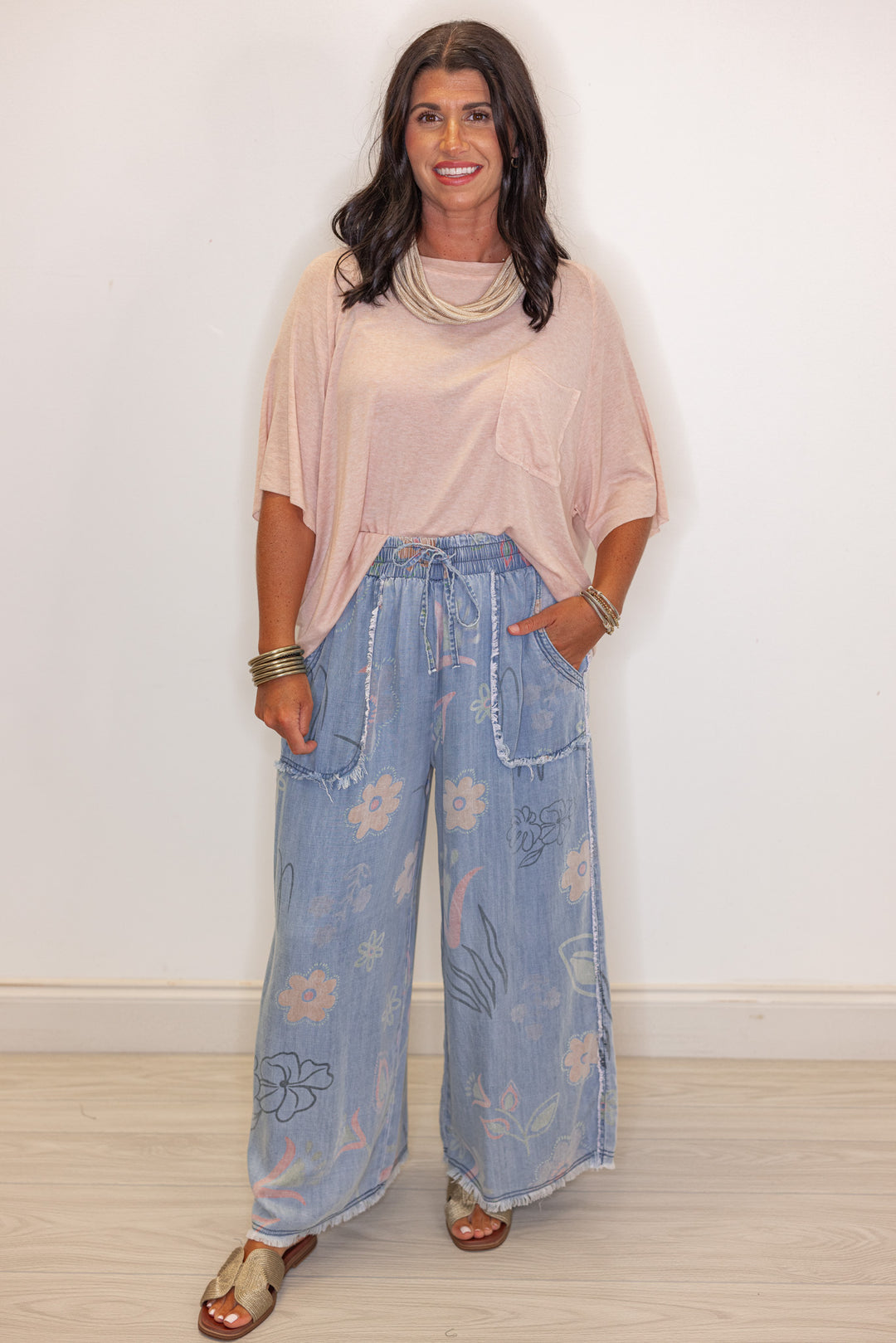 Women's baby pink stone washed jersey knit top by POL shown styled with front tuck