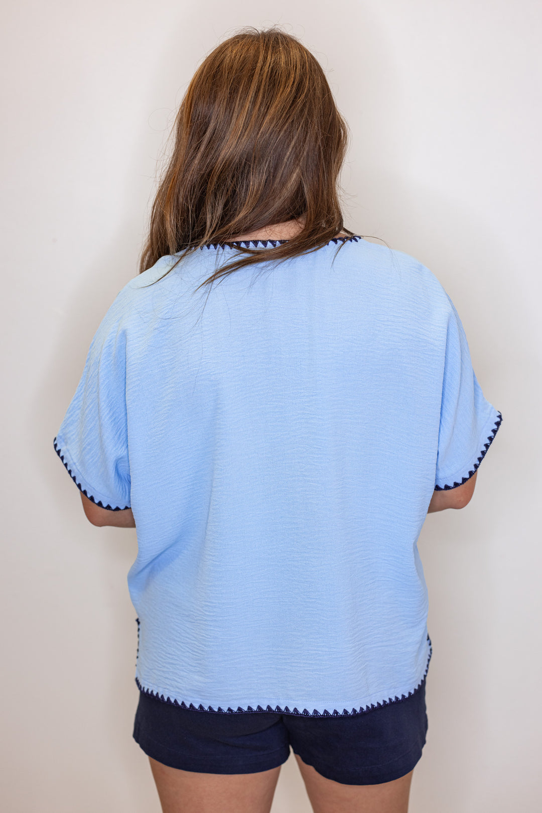 Sky blue lightweight crinkle top with embroidery stitching trim by Jodifl showing back view