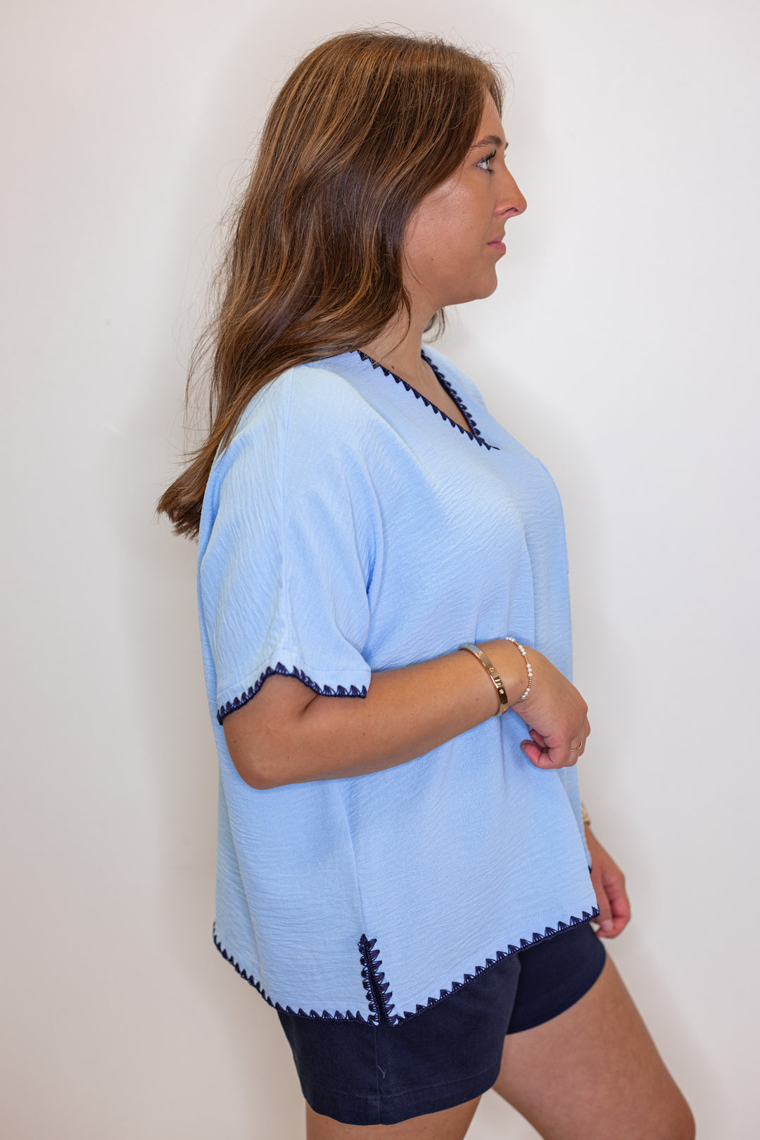 Sky blue lightweight crinkle top with embroidery stitching trim by Jodifl showing side view