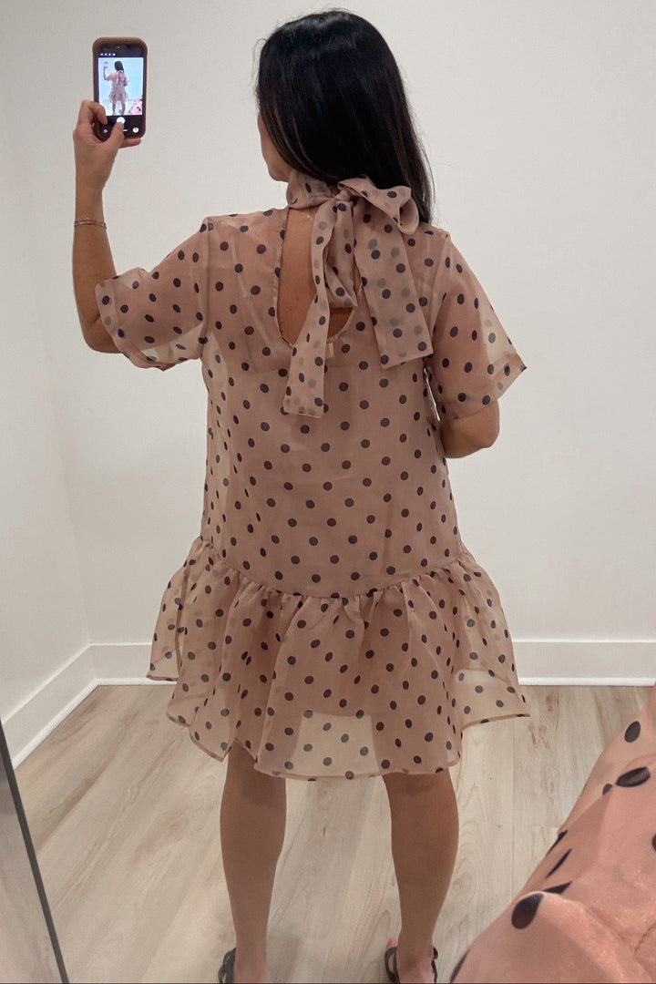 ecru with brown polka dot print short sleeve scoop back ruffle hem mini dress with back bow tie at neck