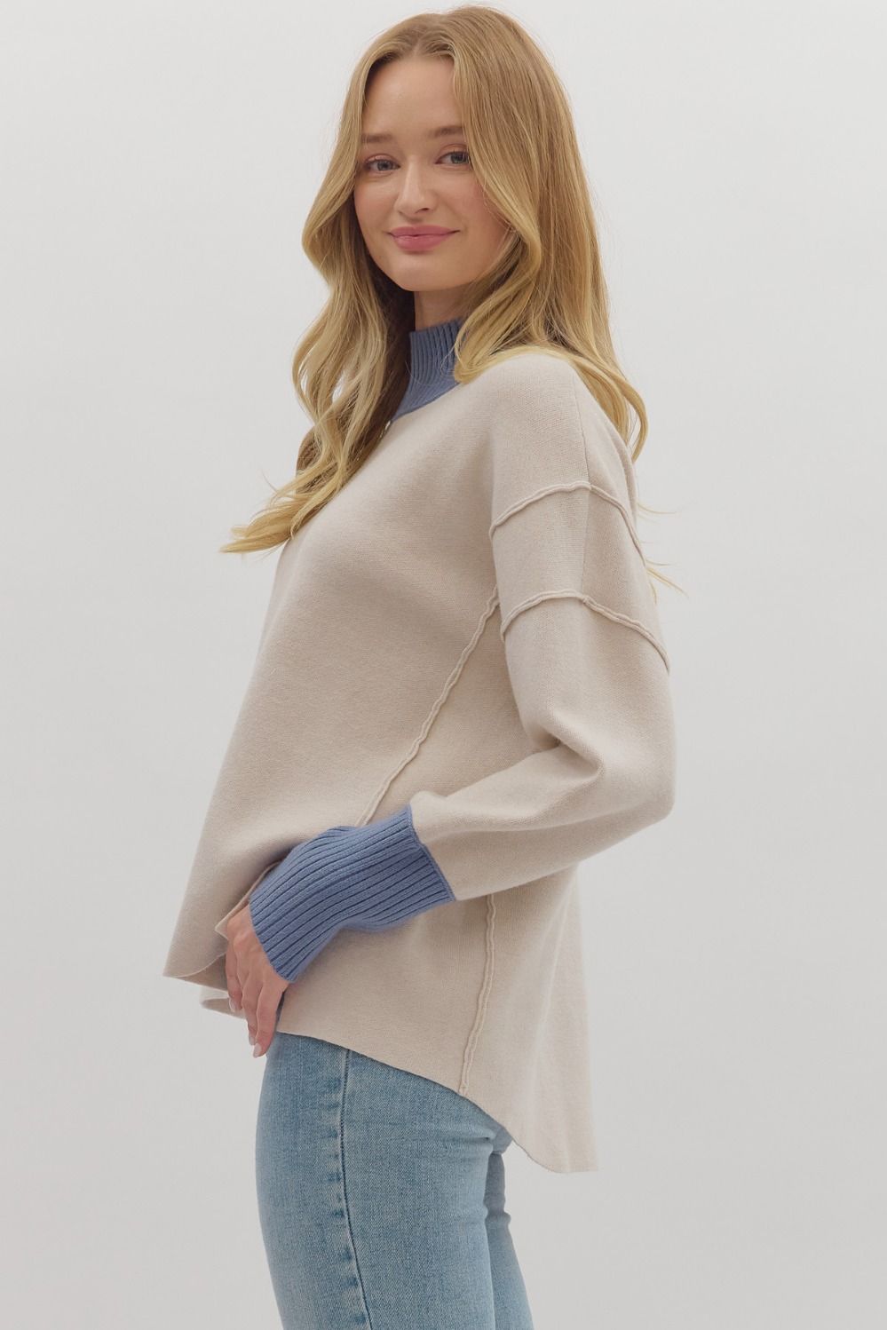 Women's ecru sweater knit pullover top with cornflower blue ribbed trim by Entro showing side view