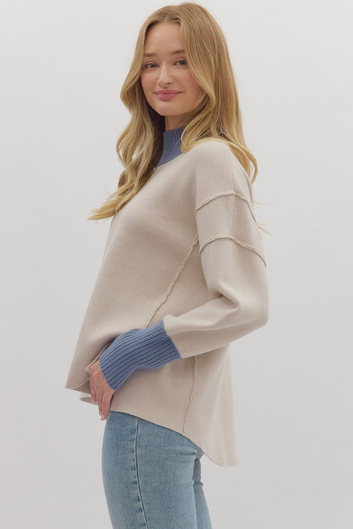 Women's ecru sweater knit pullover top with cornflower blue ribbed trim by Entro showing side view