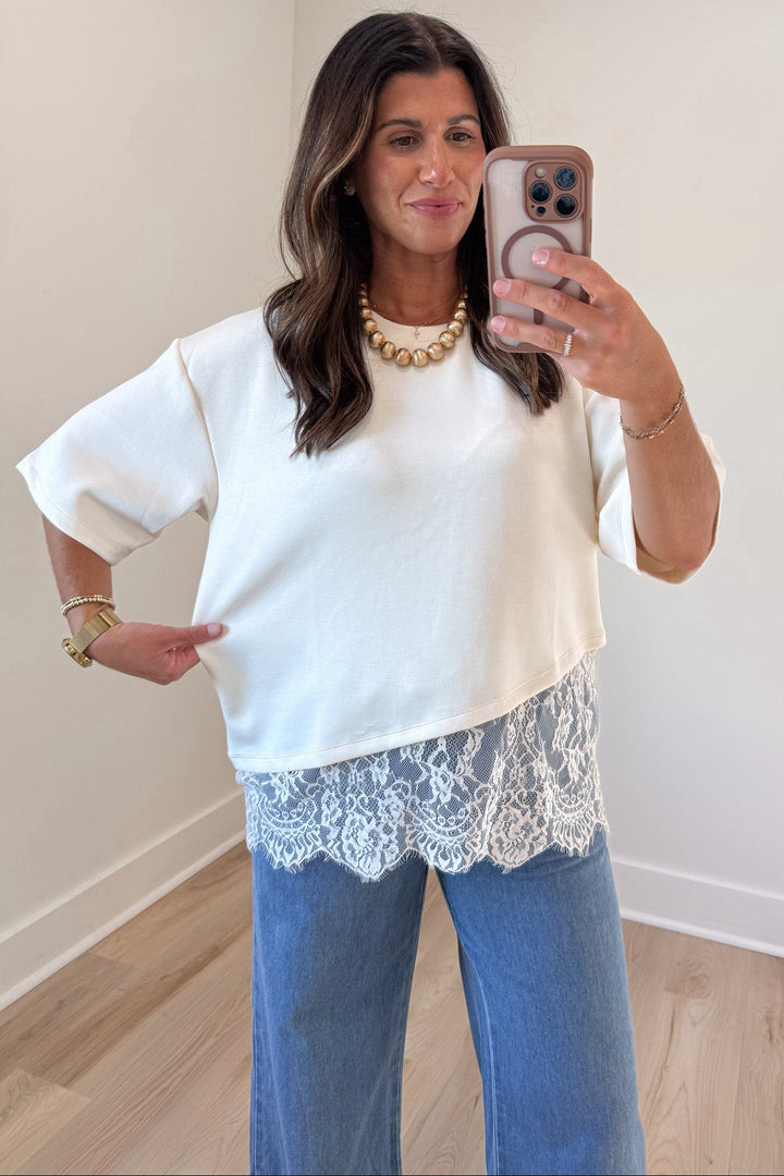 solid ecru asymmetrical tiered lace hem short sleeve crew neckline relaxed silhouette top