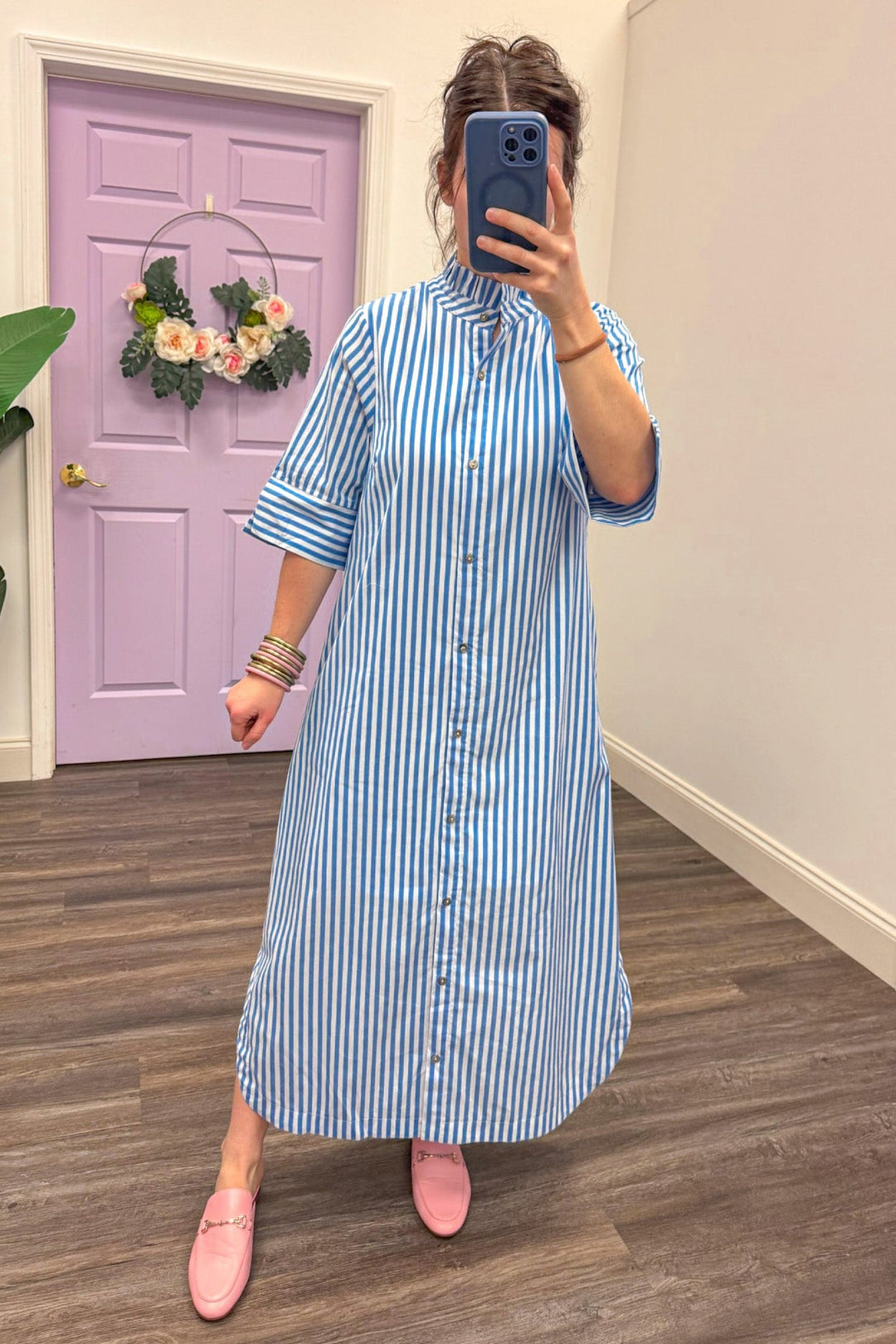 Women's blue and white striped midi dress with button up front closure
