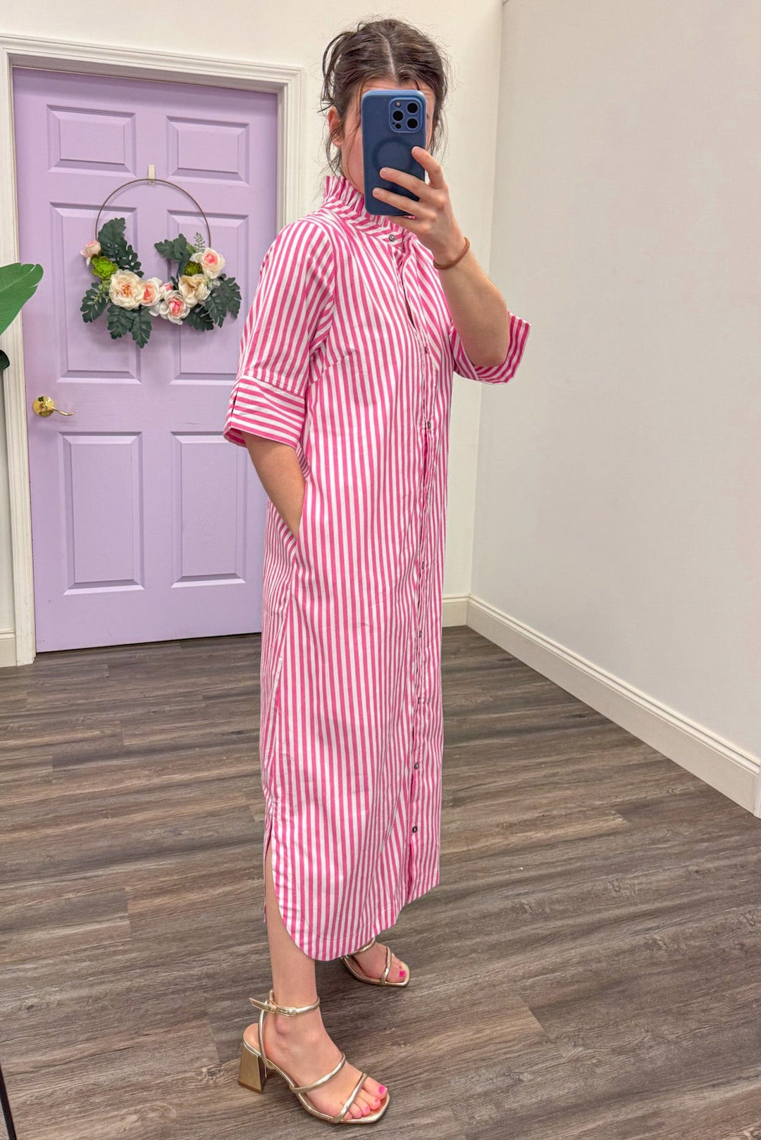 side view of Women's pink and white midi dress with pockets