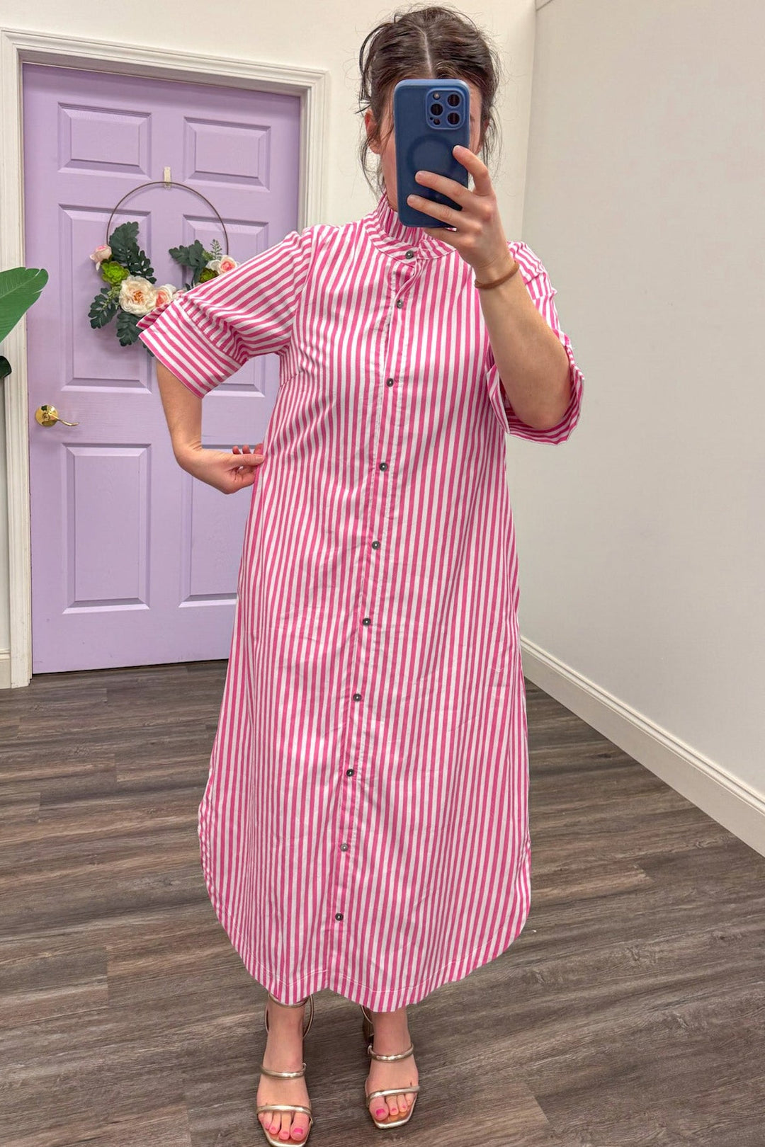 Showing the fit of Women's pink and white midi dress