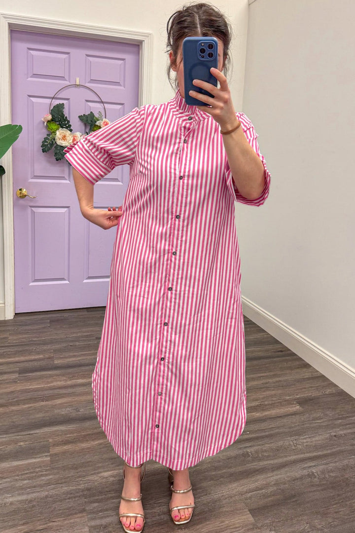 Showing the fit of Women's pink and white midi dress