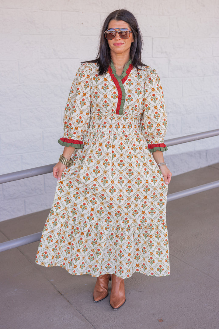 Women's ecru midi dress with orange and green floral print and ruffle trim by Entro, perfect for church