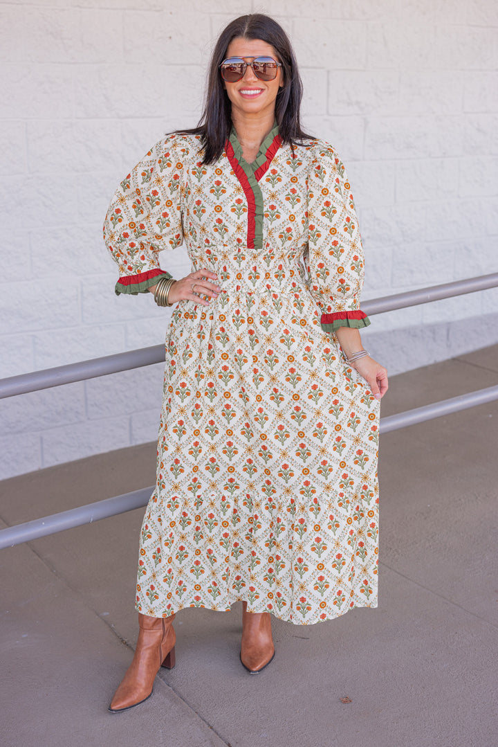 Women's ecru midi dress with orange and green floral print and ruffle trim by Entro showing full front view