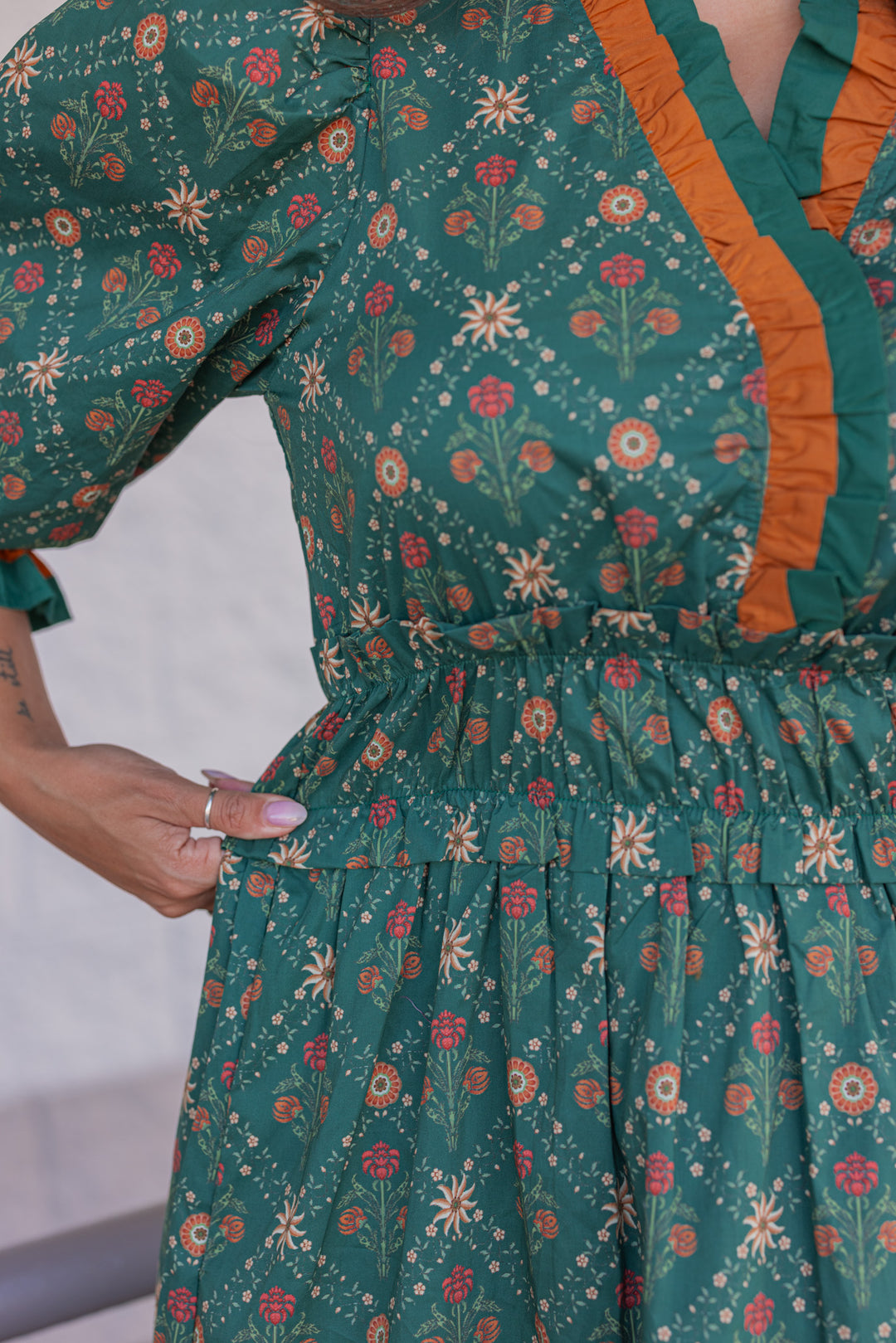 Women's hunter green midi dress with rust and taupe floral print and ruffle trim by Entro showing waistband stretch