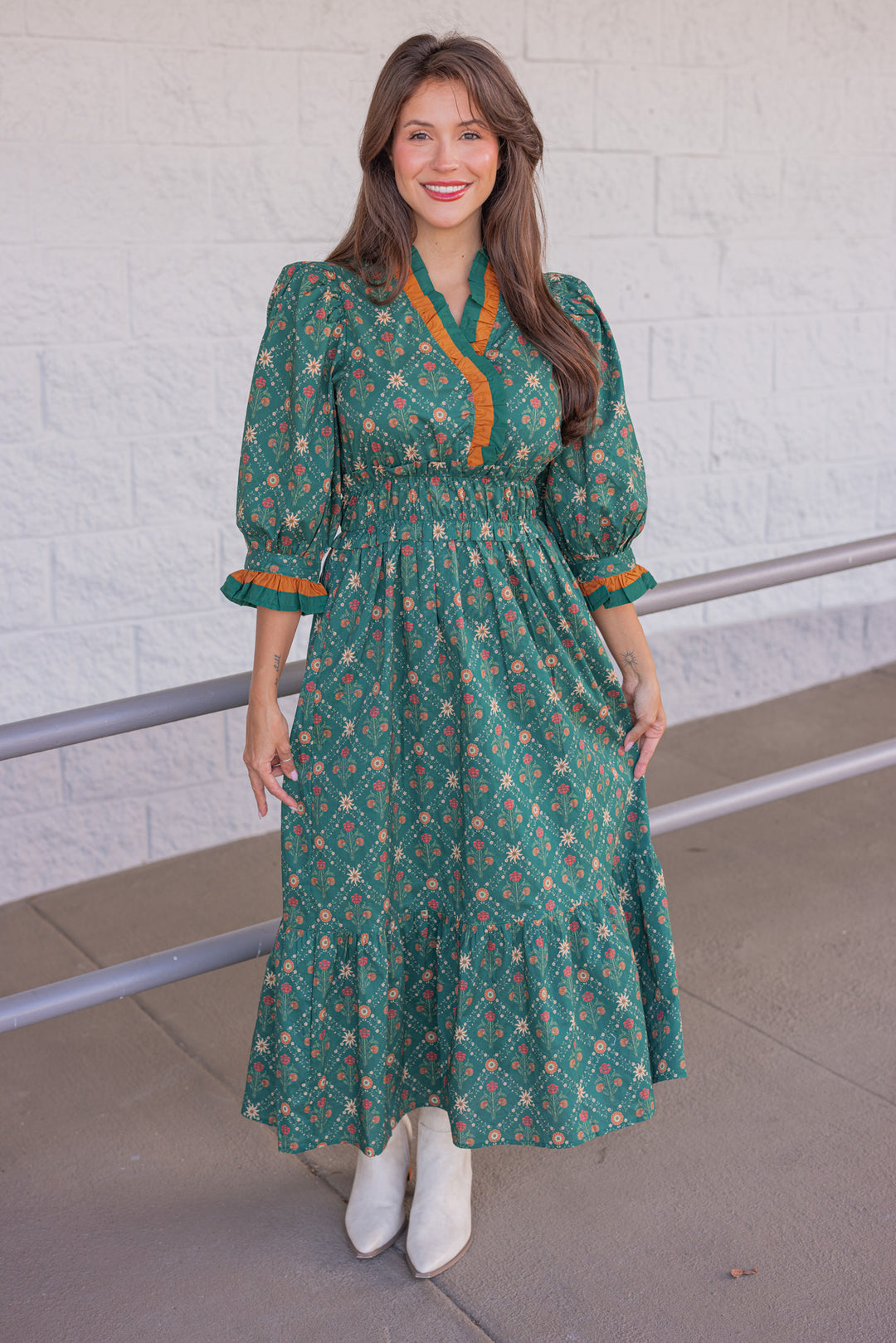 Women's hunter green midi dress with rust and taupe floral print and ruffle trim by Entro showing full front view