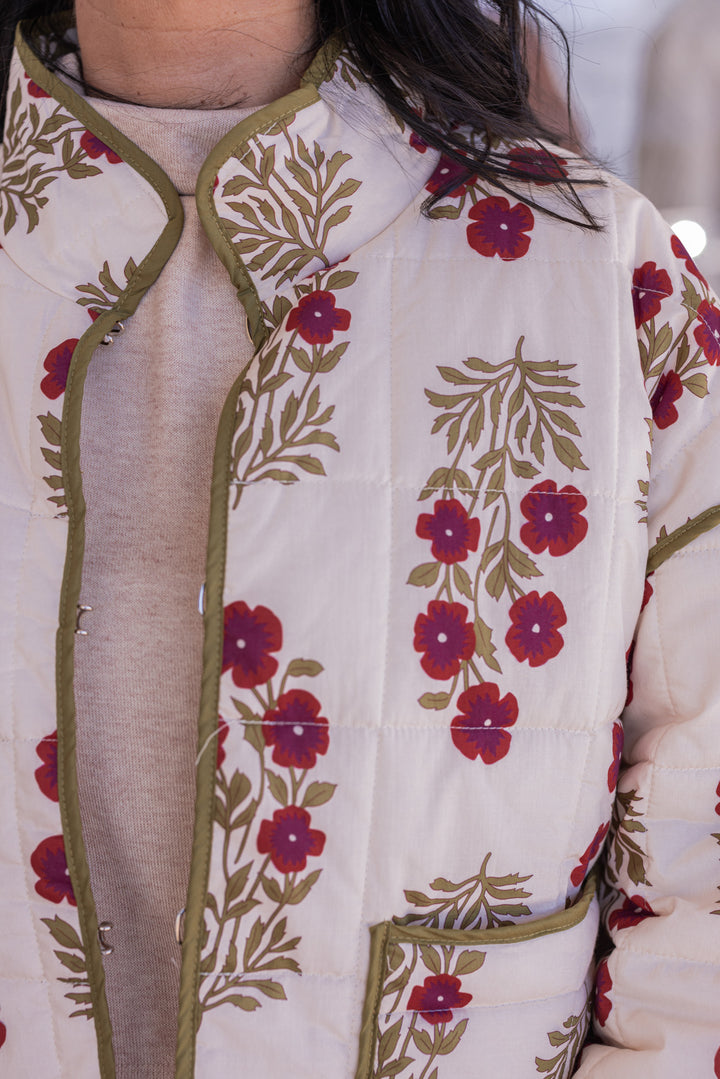 Women's ecru, dark red and olive floral print quilted puffer jacket by Entro showing close look at floral pattern