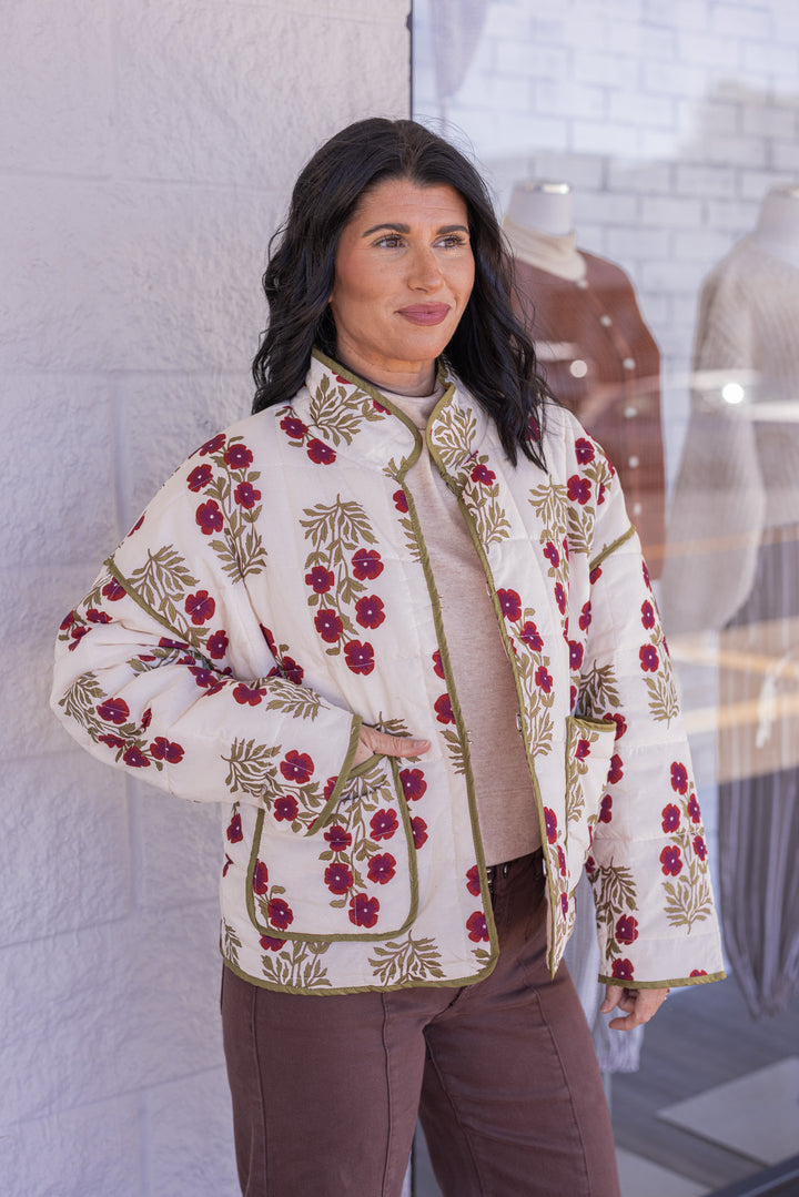 Women's ecru, dark red and olive floral print quilted puffer jacket by Entro showing patch front pockets