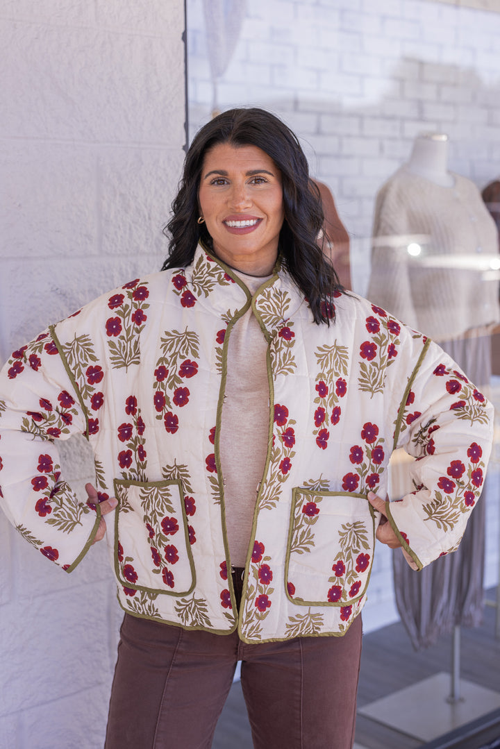 Women's ecru, dark red and olive floral print quilted puffer jacket by Entro showing true to size fit