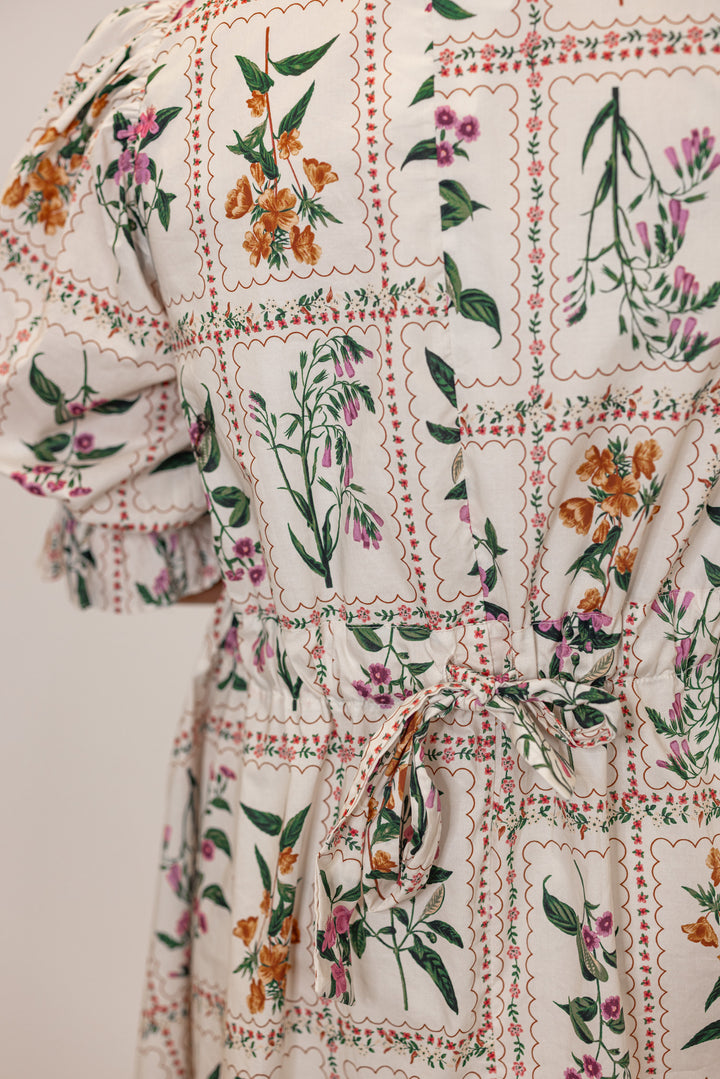 Women's ecru dress with multicolor floral panel print and adjustable cinch waist by Entro showing floral pattern