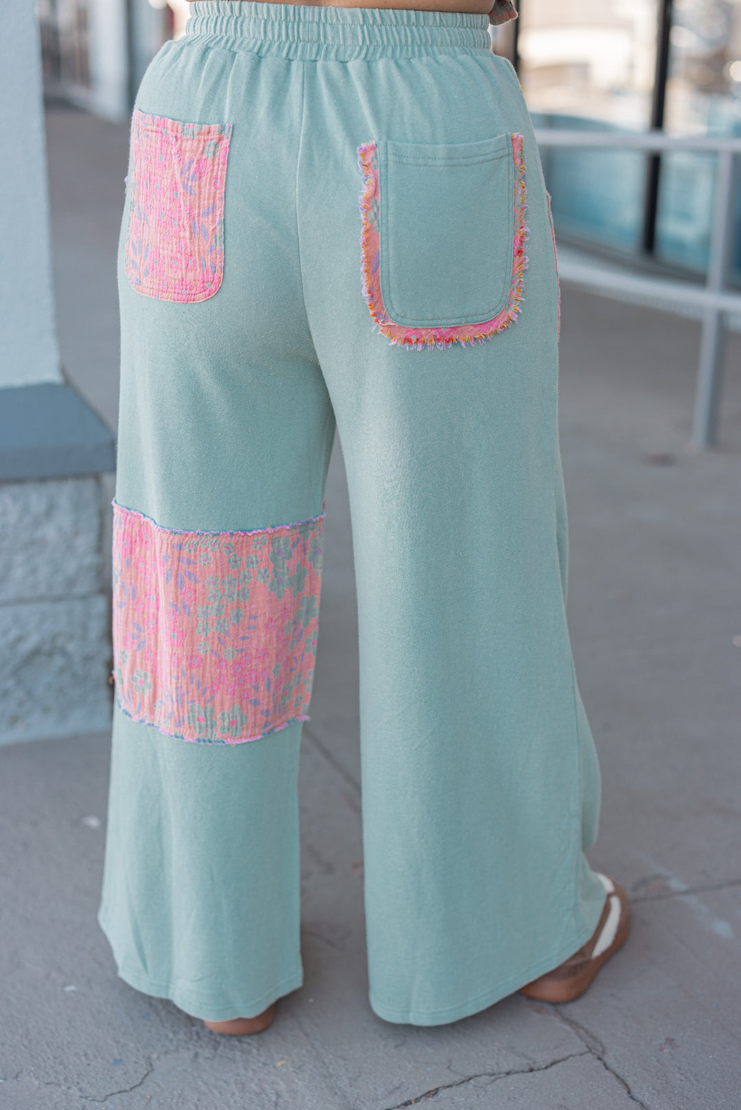 Women's french terry knit sage pants with frayed floral patch gauze details by Easel showing back view