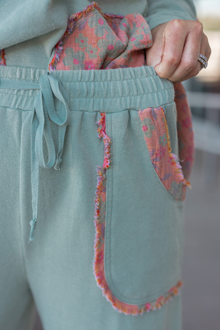 Women's french terry knit sage pants with frayed floral patch gauze details by Easel showing elastic waistband