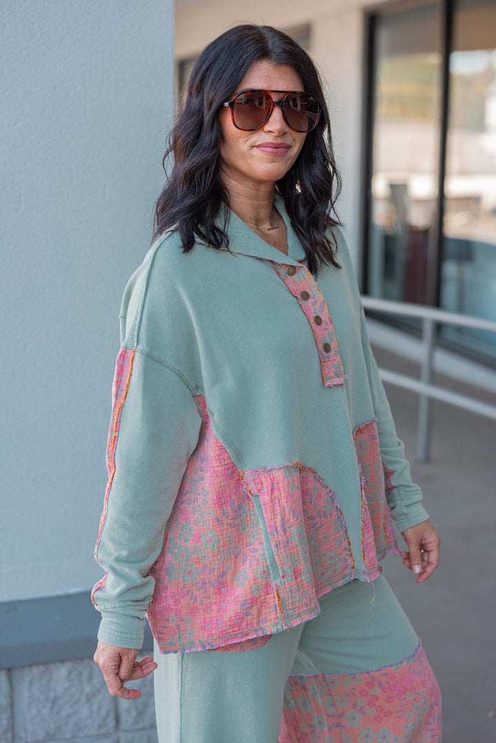 Women's french terry knit sage pullover top with frayed floral patch gauze details by Easel showing side view