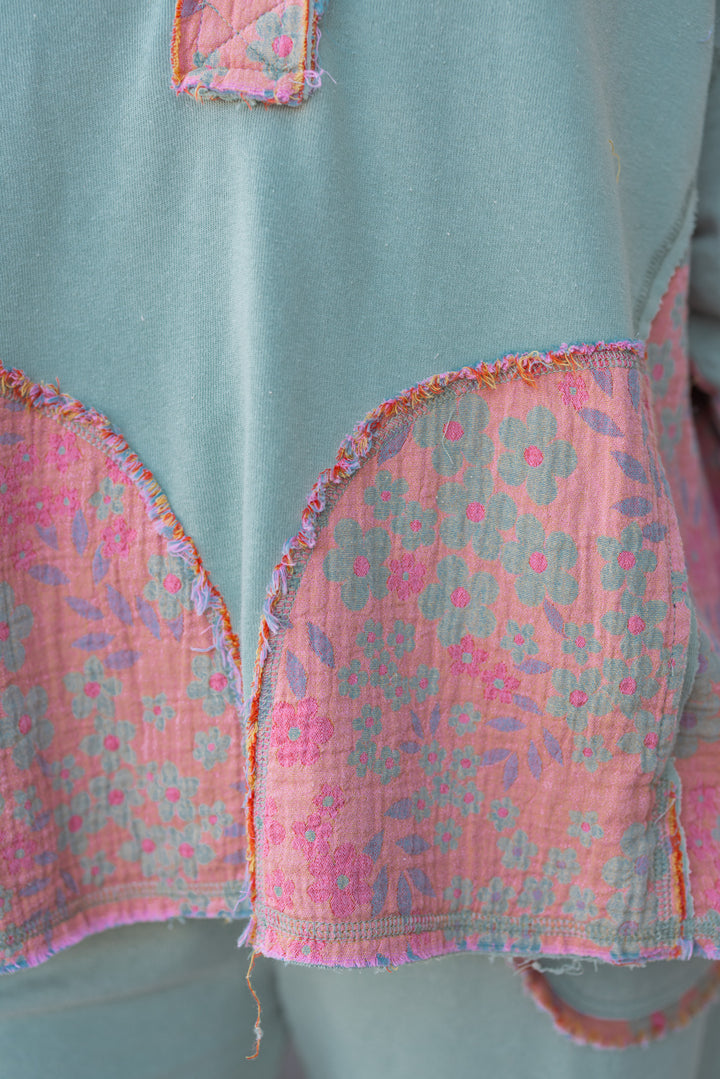 Women's french terry knit sage pullover top with frayed floral patch gauze details by Easel showing up close view of floral pattern