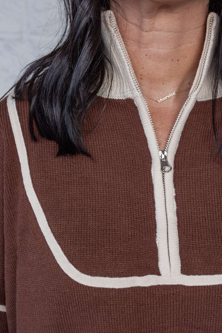 Women's brown knit sweater with cream trim by She + Sky showing zipper bodice