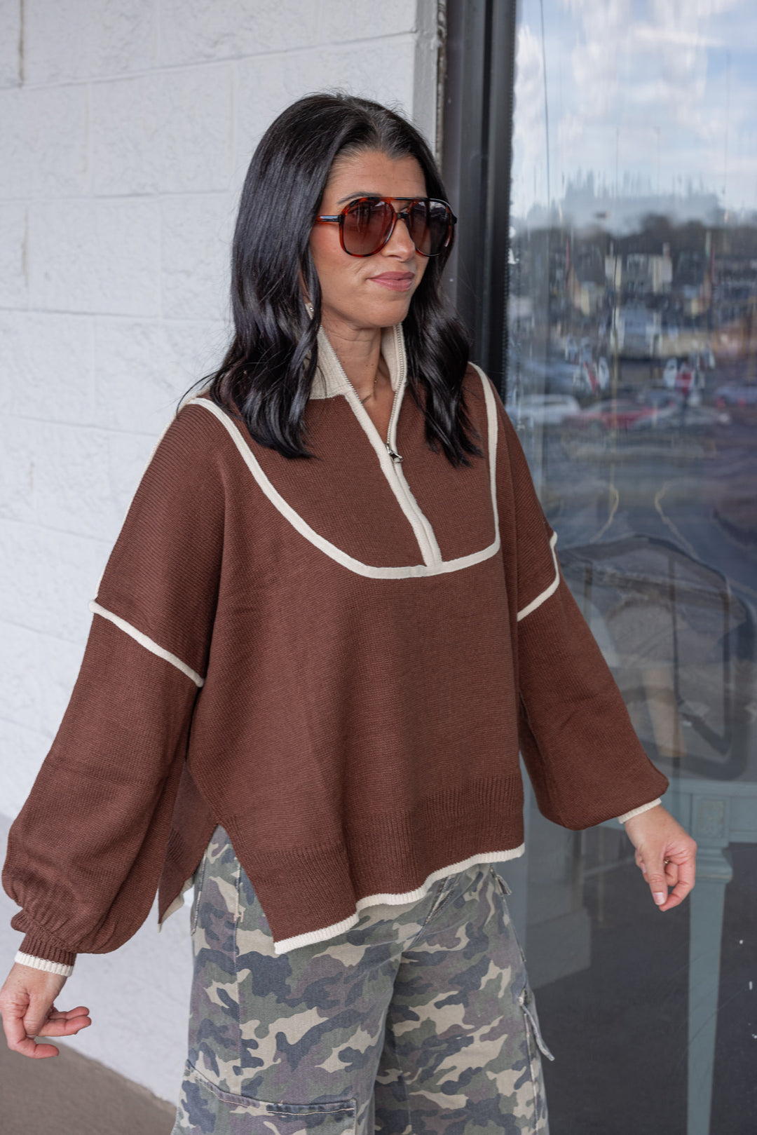 Women's brown knit sweater with cream trim and a zipper bodice by She + Sky showing up close, slightly angled view