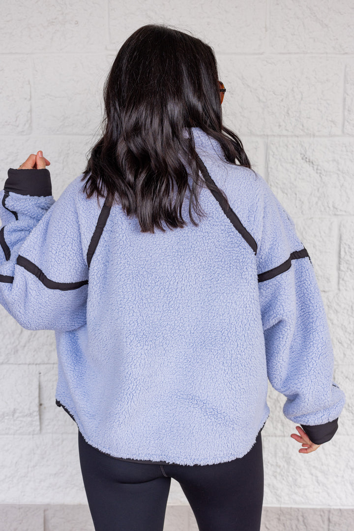 Women's bluish lavender sherpa quarter zip pullover jacket with black trim by Rae Mode showing up close back view