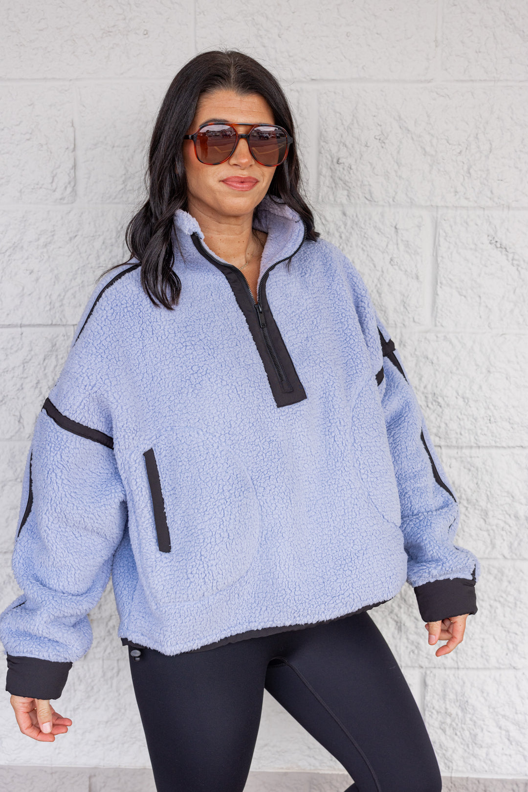 Women's bluish lavender sherpa quarter zip pullover jacket with black trim by Rae Mode showing slightly angled view
