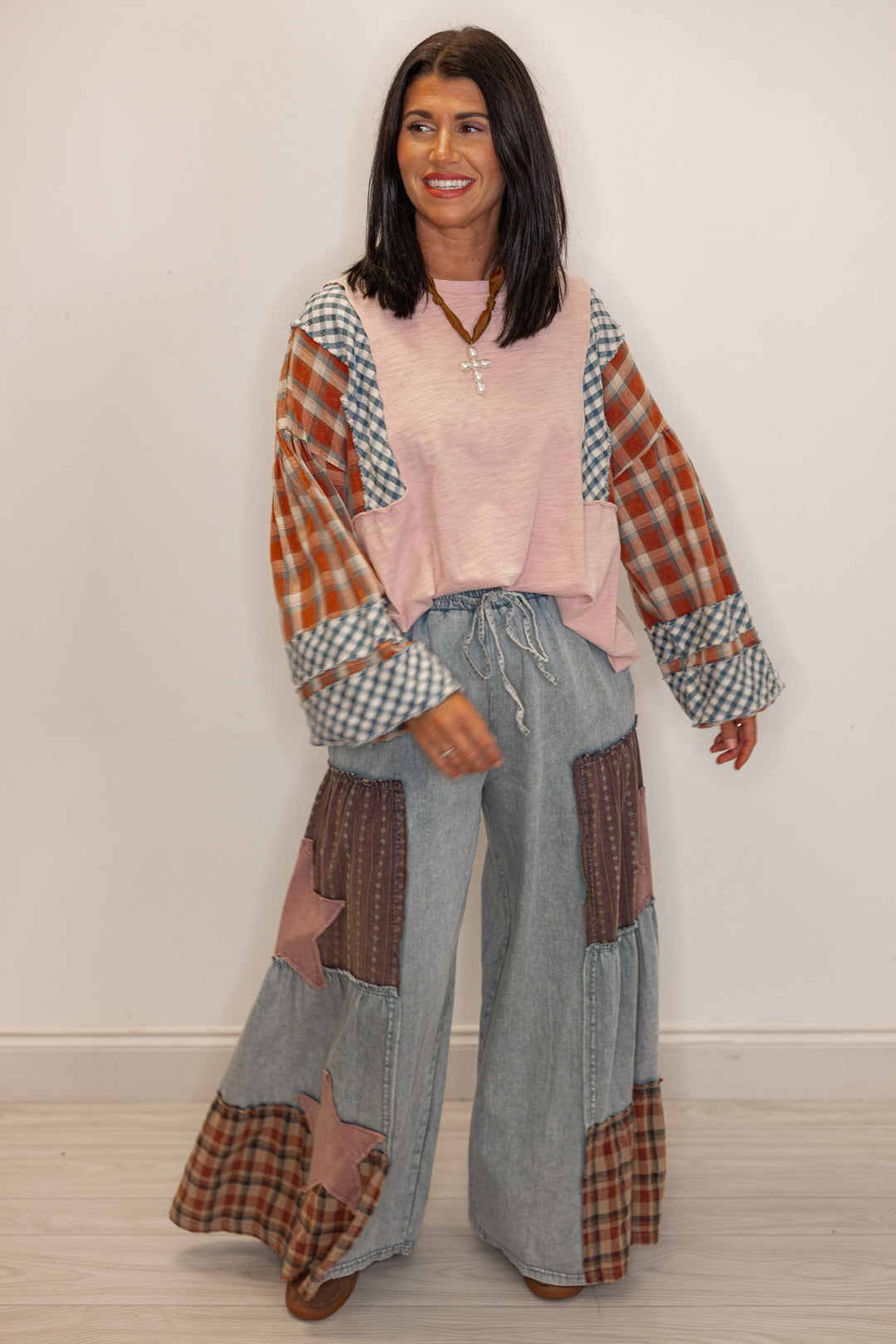 Women's Patchwork, flowy, wide leg jeans  paired with a plaid and pink long sleeve tee