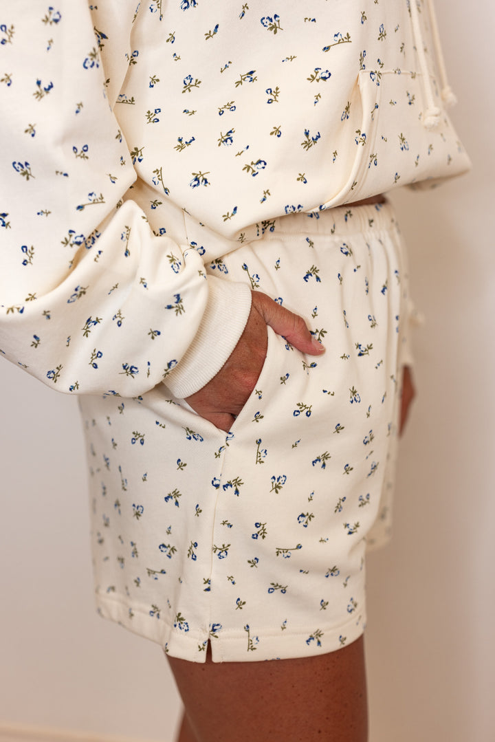 Women's cream french terry knit shorts with blue floral print by Wishlist showing up close side view