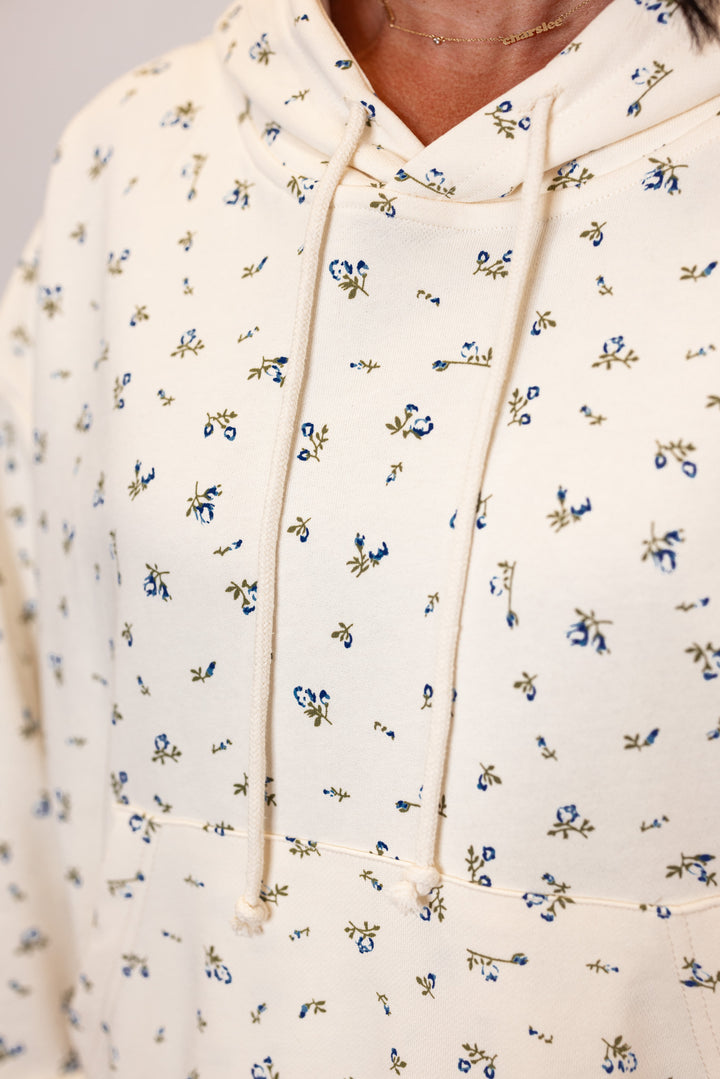 Women's cream french terry knit hooded top with blue floral print by Wishlist showing up close view of floral print