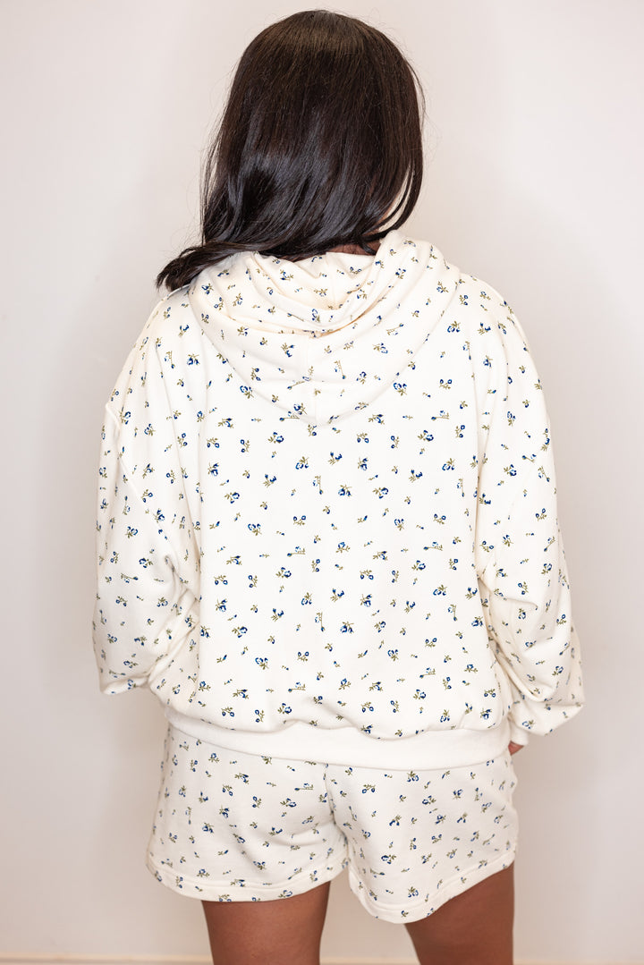 Women's cream french terry knit hooded top with blue floral print by Wishlist showing back view
