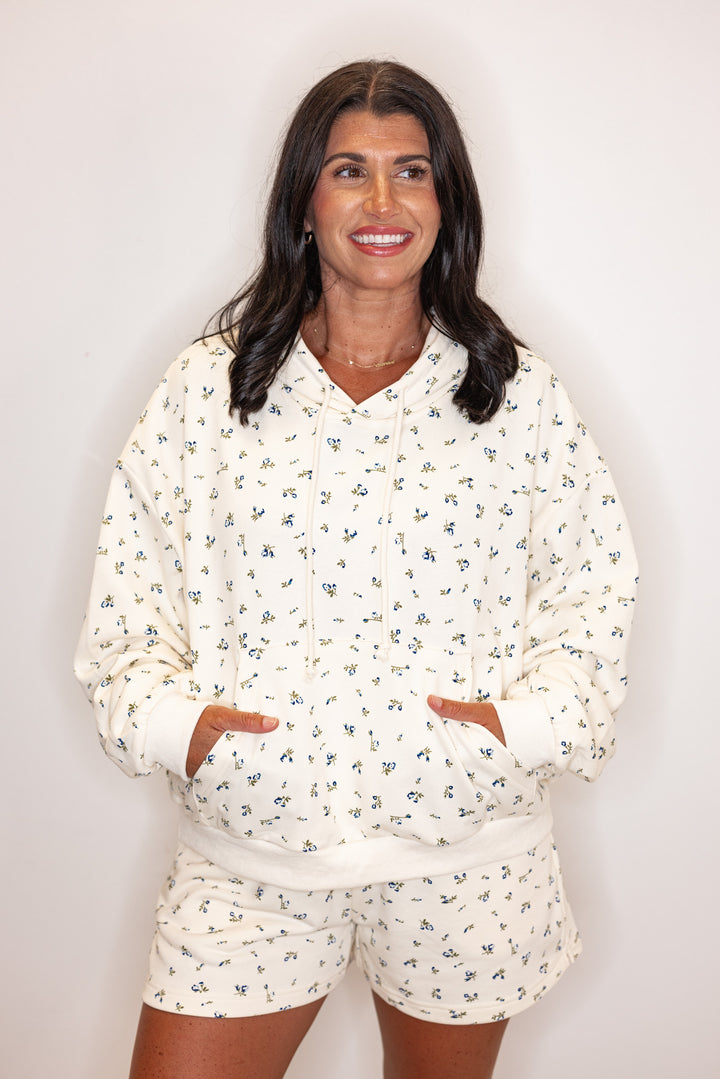Women's cream french terry knit hooded top with blue floral print by Wishlist