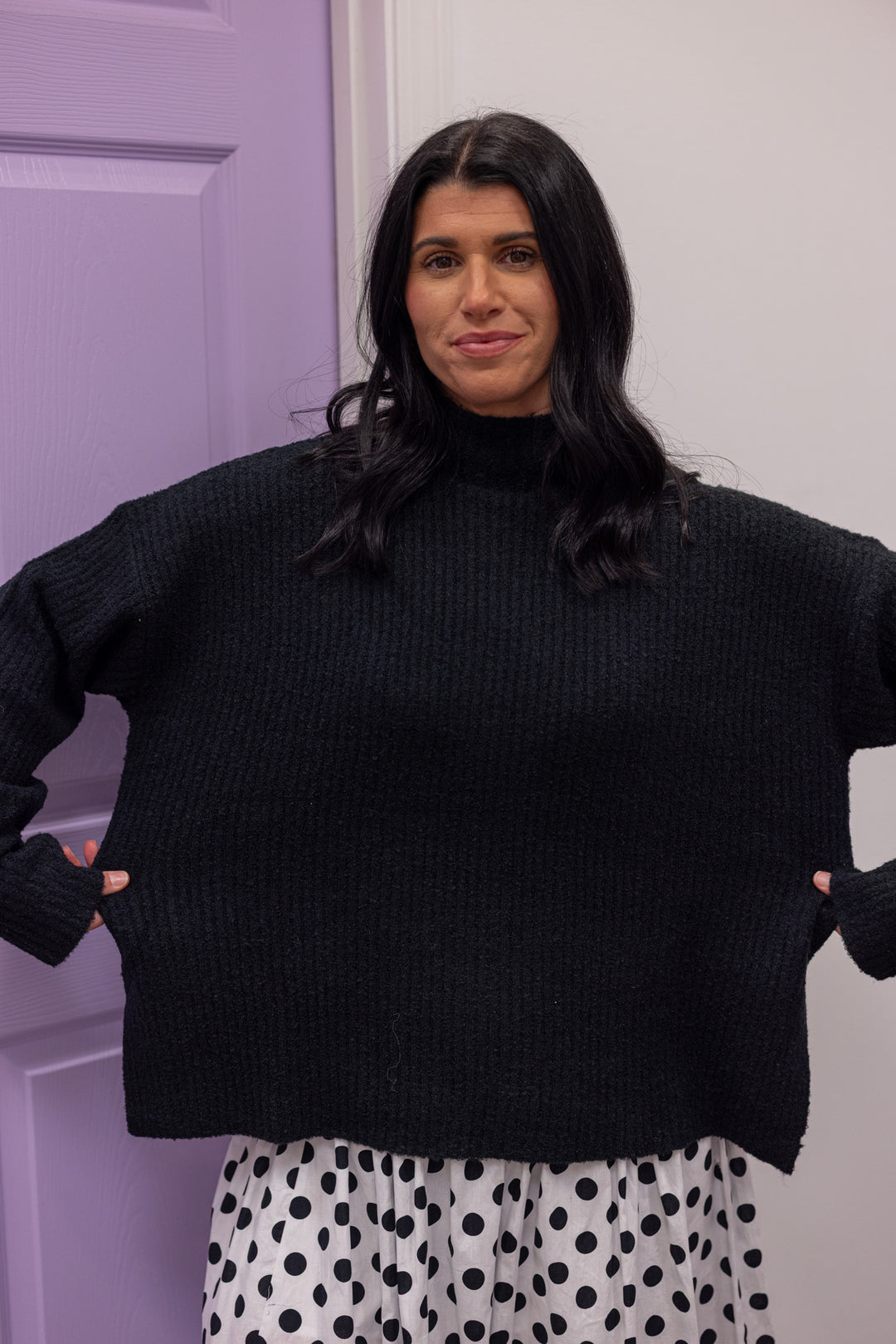 Women's black ribbed knit mock neck sweater top with side slits by Mustard Seed showing relaxed fit