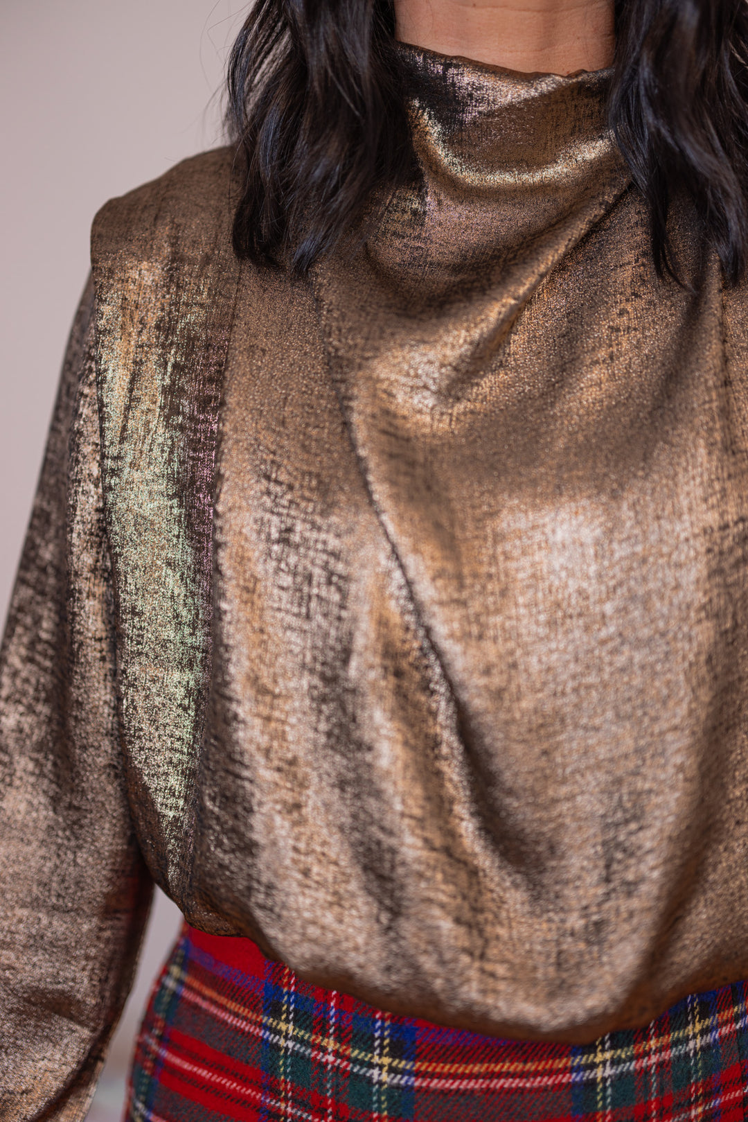 Women's gold metallic cropped bubble hem top with cowl mock neck by Glam showing up close view