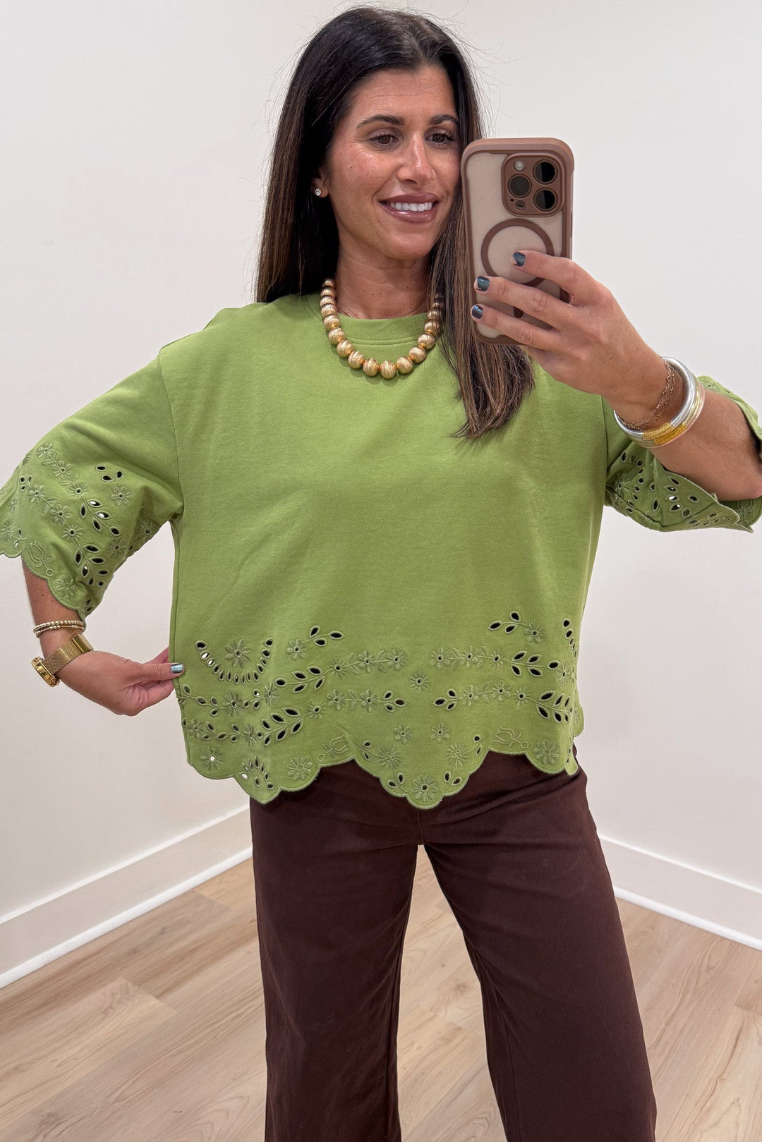 solid grass green floral eyelet accents scalloped hem half sleeve relaxed silhouette knit top